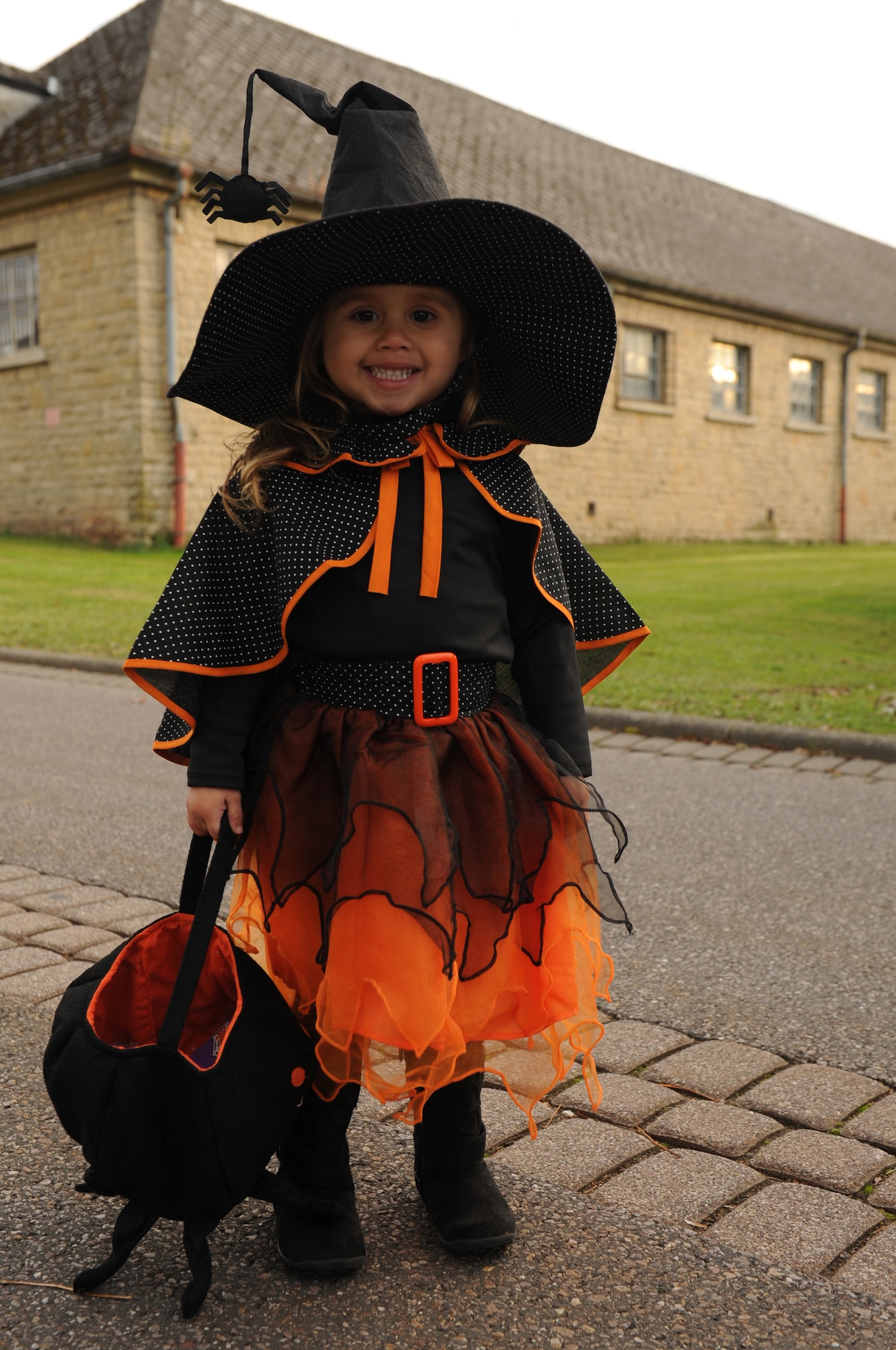 BITBURG ANNEX, Germany -- Alana Acevedo, daughter of Staff Sgt. Josue Acevedo, 52nd Aircraft Maintenance Squadron weapons load crew technician, poses for the camera before entering the haunted house here Oct. 27.  The haunted house is scheduled for Oct. 27-29 in Bldg. 2032 and 2033 at the French Casern on Bitburg Annex. Admission is $5 for adults and $3 for children younger than 13. The doors open at 5 p.m. every night. The first hour of the night is for younger children who just want to trick-or-treat. (U.S. Air Force photo/Airman 1st Class Brittney Frees)