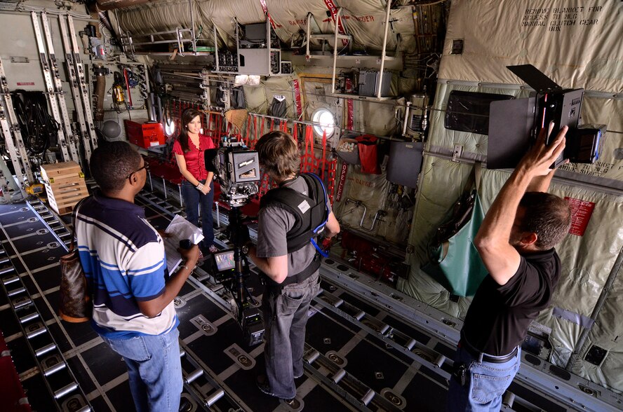 Bryan Simmons, a Headline News producer, Matthew Lingerfelt, a steadicam operator with CNN, and senior CNN photojournalist, Ferre Dollar, tape intro segments at Dobbins with Robin Meade for her Veterans Day Salute to Troops special, Oct. 27. Meade shot her intros in and around the C-130 aircraft at Dobbins as an appropriate backdrop for her ongoing tribute to military personnel on her Morning Express program on Headline News.   (U.S. Air Force photo/ Brad Fallin)