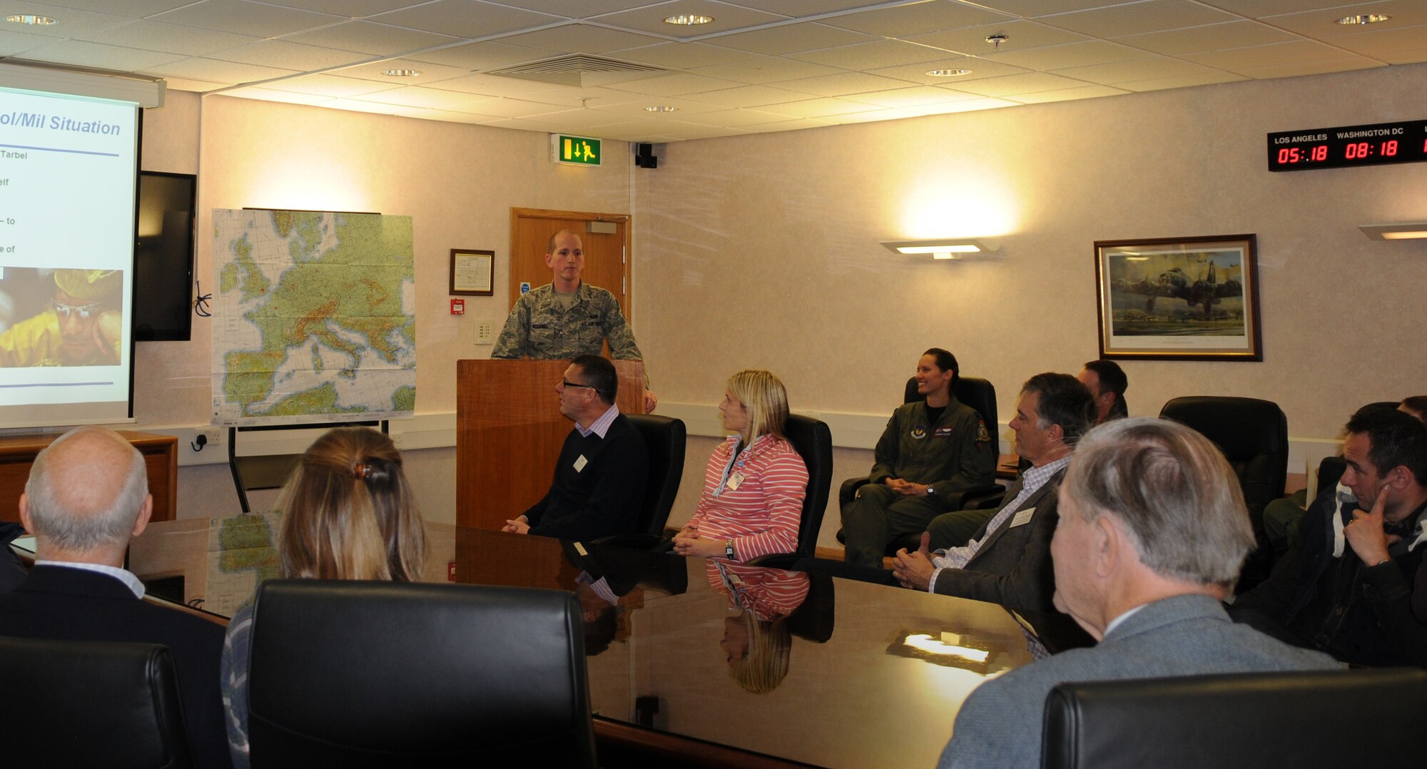 RAF MILDENHALL, England – Senior Airman Lance McDaniel, 100th Operations Group, provides a mock Operation Unified Protector intelligence briefing to honorary commanders and base commanders during Honorary Commander’s Day here Oct. 27, 2011. The purpose of the intelligence brief was to prepare the honorary commanders to “fly” in support of OUP in the KC-135 Stratotanker flight simulator. (U.S. Air Force photo/Senior Airman Rachel Waller)