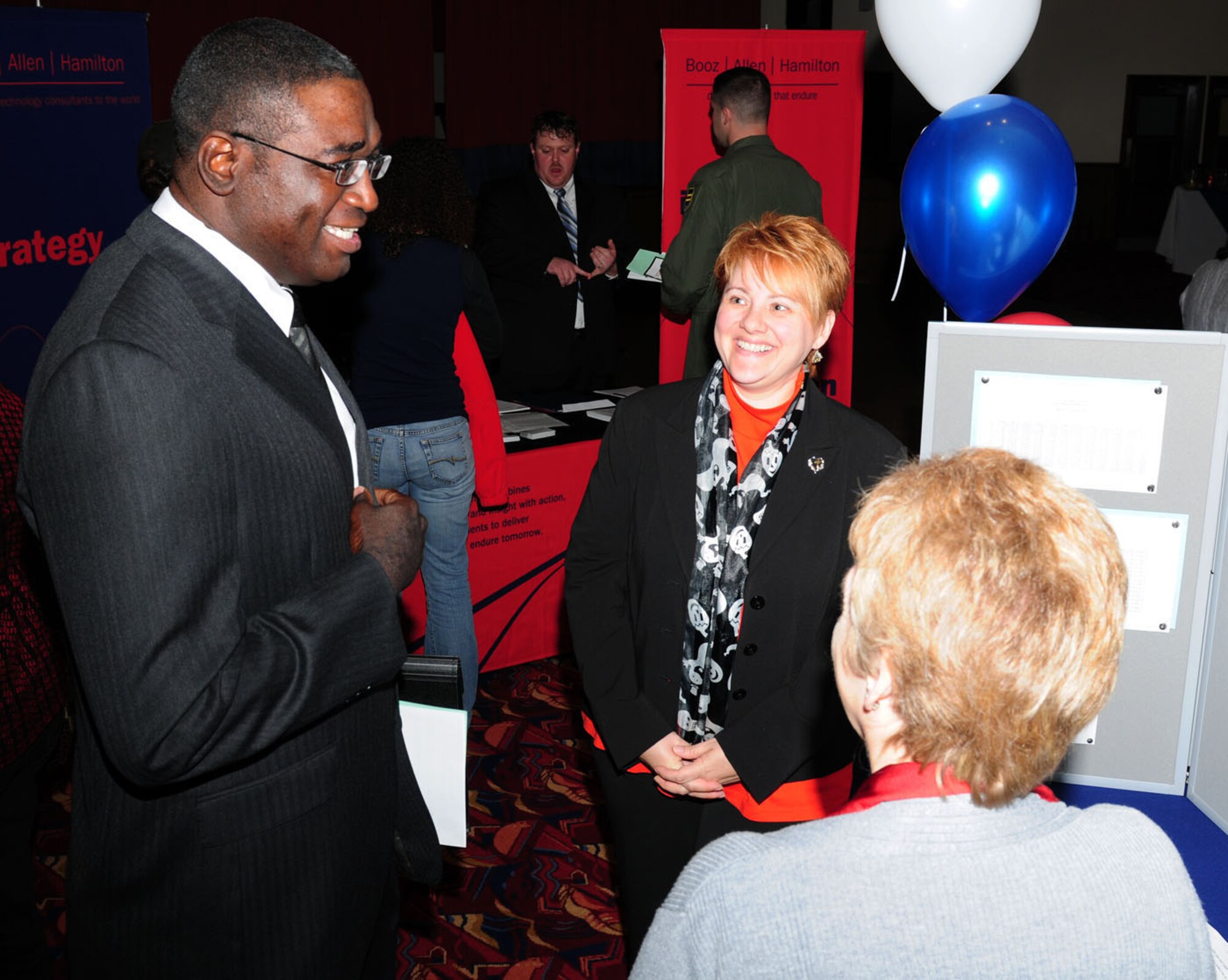 RAF MILDENHALL, England -- Kim Chamberlain, right, and Kristina Lee, both from 100th Force Support Squadron Civilian Personnel office, discuss job opportunities with Delain Hayes, Jr., 423rd Force Support Squadron, RAF Alconbury, at the Employment Expo here Oct. 27, 2011. Several employers from the states, along with employers from on base, attended the event to talk to people interested in job opportunities. More than 200 people attended the event, which was sponsored by the RAF Mildenhall Airman and Family Readiness Center. (U.S. Air Force photo/Karen Abeyasekere)