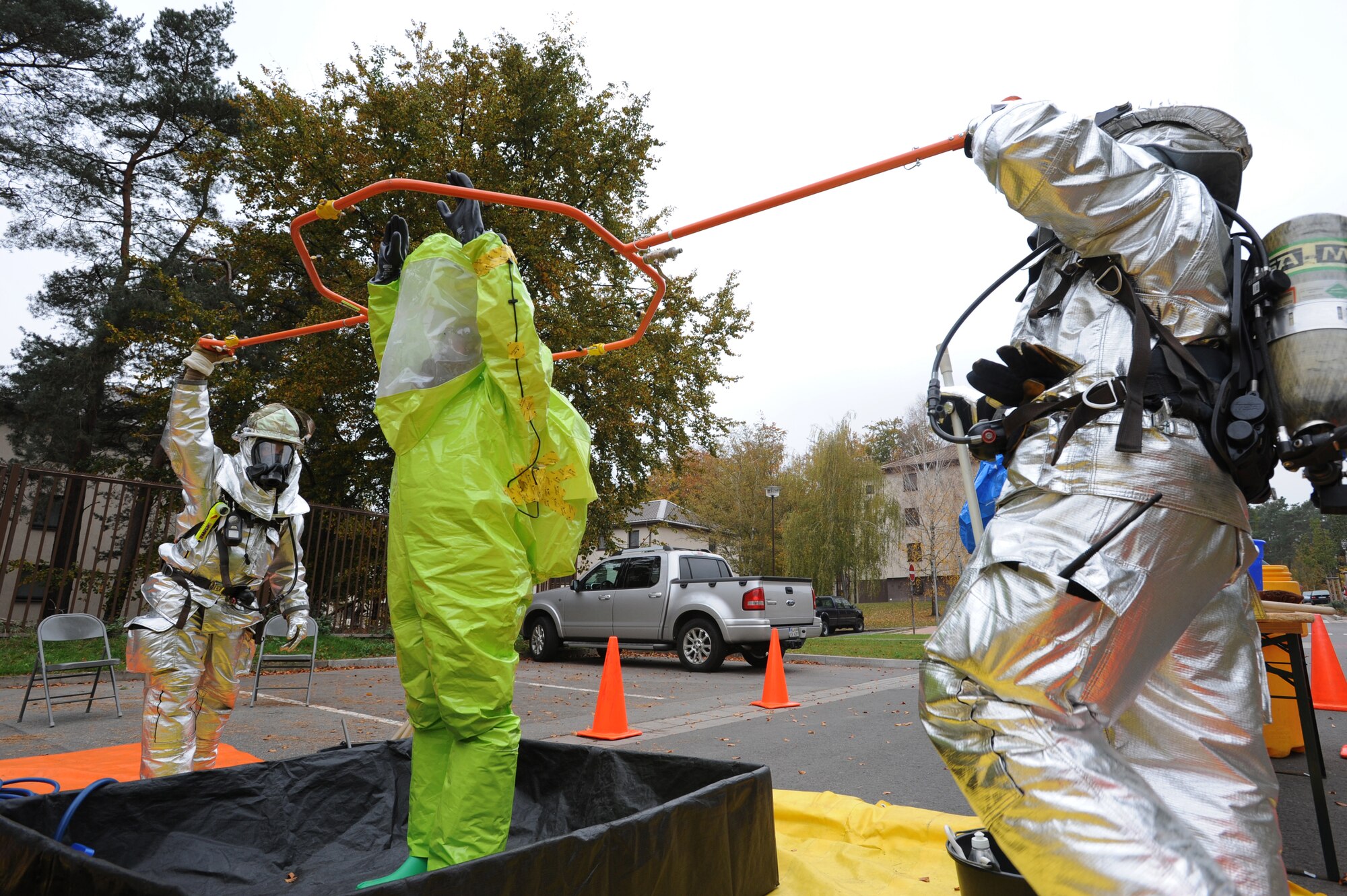 Air Force Tech. Sgt. Matthew Dodge, 86th Aerospace Medicine Squadron, gets decontaminated by members of the 886th Civil Engineer Squadron at a hazardous materials checkpoint during a joint agency response exercise, Ramstein Air Base, Germany, Oct. 27, 2011. The exercise, designed to educate and train U S Air Force and Army servicemembers from six emergency response agencies, provided the skills needed for a real world response.(U.S. Air Force by Airman 1st Class Caitlin O'Neil-McKeown)