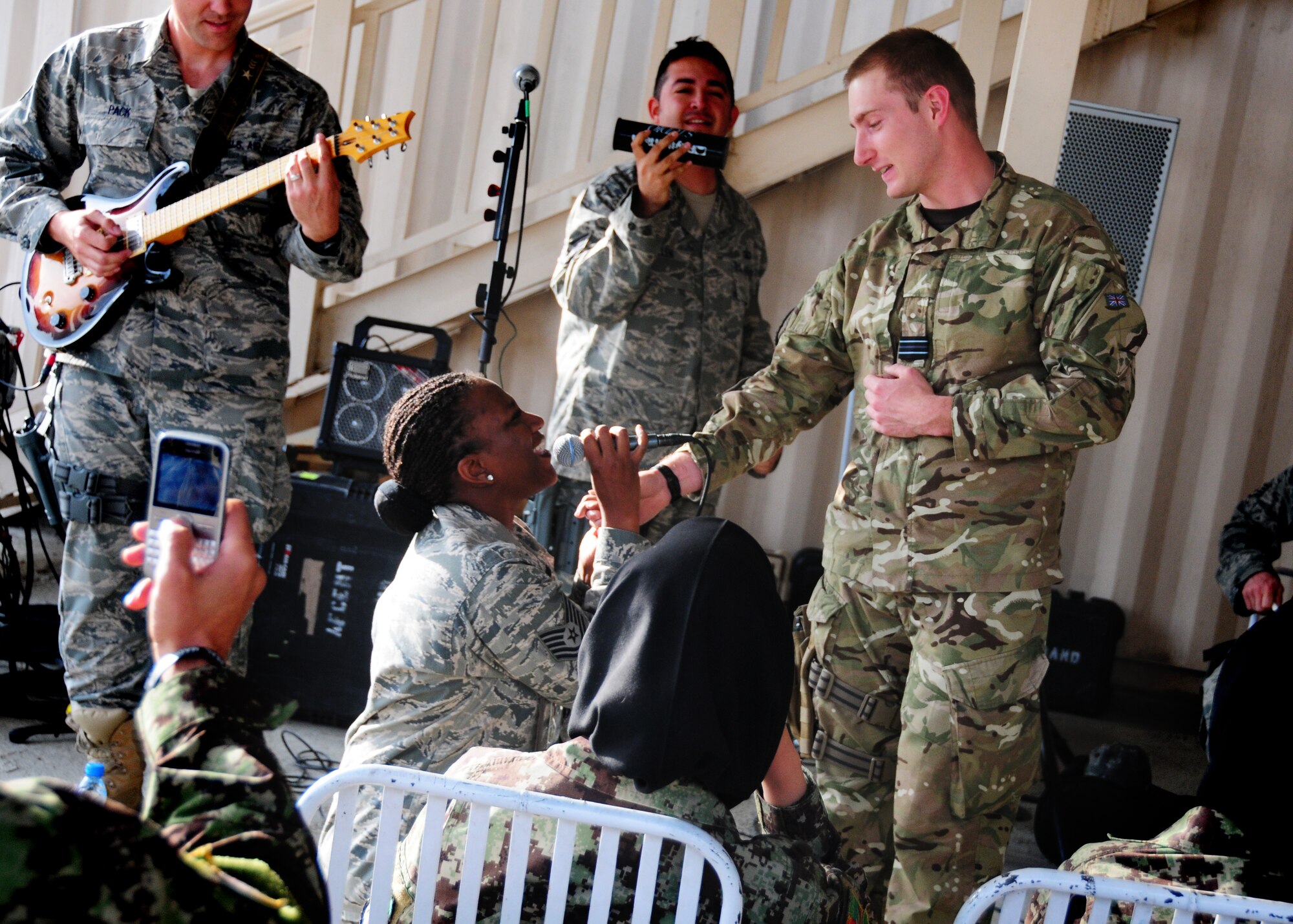 Tech. Sgt. Amber Grimes sings to Royal Air Force Flt. Lt. Adam Calvesbert at Thunder Lab at Kabul International Airport, Kabul, Afghanistan October 26, 2011.  “Top Cover” was performing for coalition forces deployed to the 438th Air Expeditionary Wing.  (U.S. Air Force photo by Senior Airman Amber Williams)
