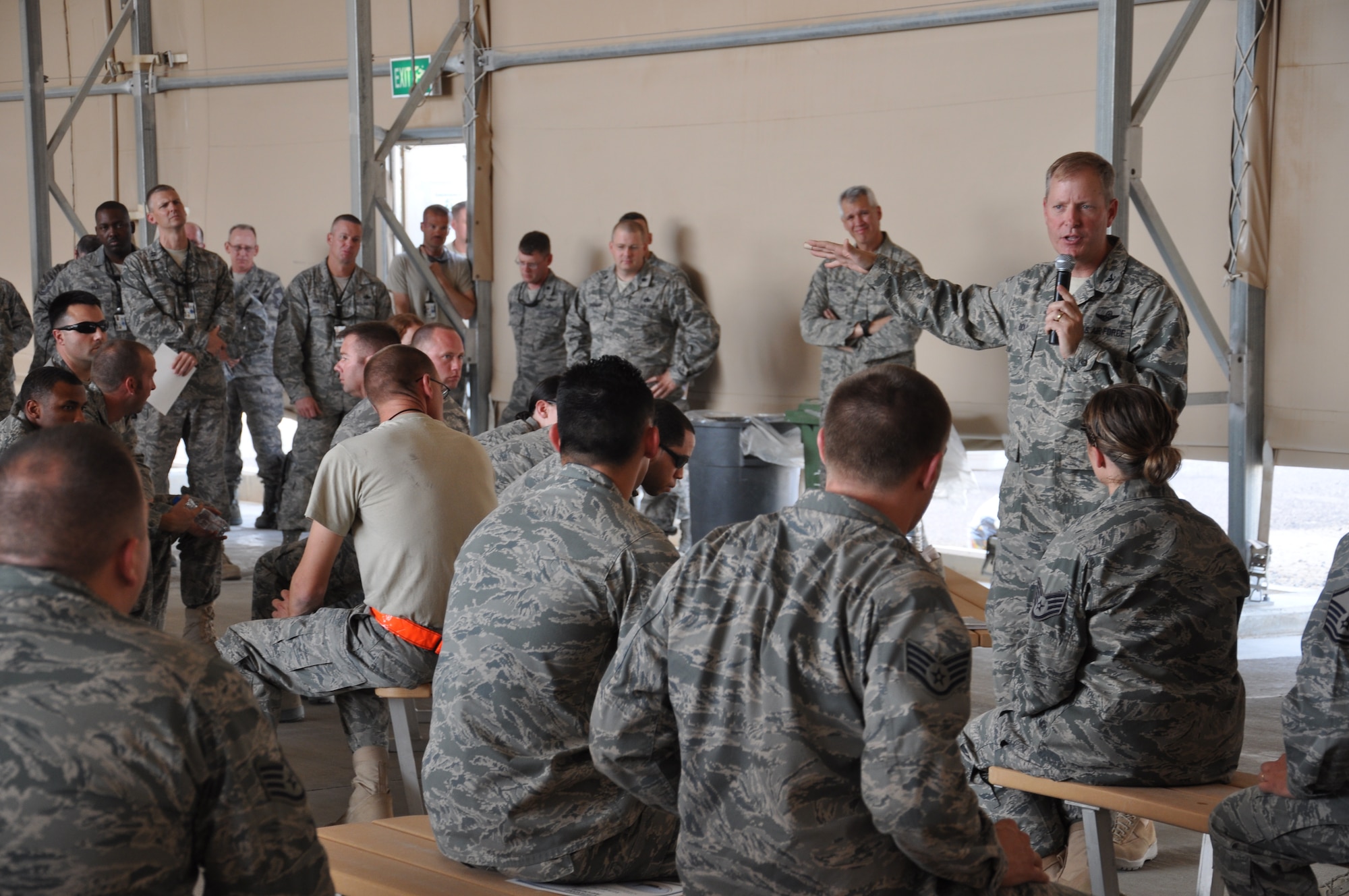 Colonel Michael Zick, 386th Air Expeditionary Wing commander, addresses members of the 386th Expeditionary Maintenance Group and 386th Expeditionary Mission Group, congratulating them on their outstanding performance during the Multi-MAJCOM Staff Assistance Visit. (U.S. Air Force photo by Senior Airman Rachelle Elsea)