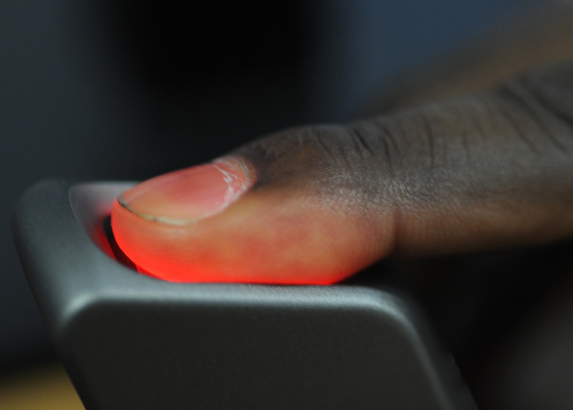 SPANGDAHLEM AIR BASE, Germany – Tech. Sgt. Kejuan Bostick, 52nd Aircraft Maintenance Squadron, has his finger scanned to verify his identity during a new Common Access Card issue at the military personnel section here Oct. 26. The Department of Defense recently began removing social security numbers from Common Access Cards to protect the personal identity information of service members and their families. This initiative has three phases, which began with the removal of family member and all active-duty social security numbers, and social security numbers embedded in bar codes will be removed beginning in 2012. ID cards won’t be replaced unless the current card is expired or damaged. (U.S. Air Force photo/Senior Airman Christopher Toon)