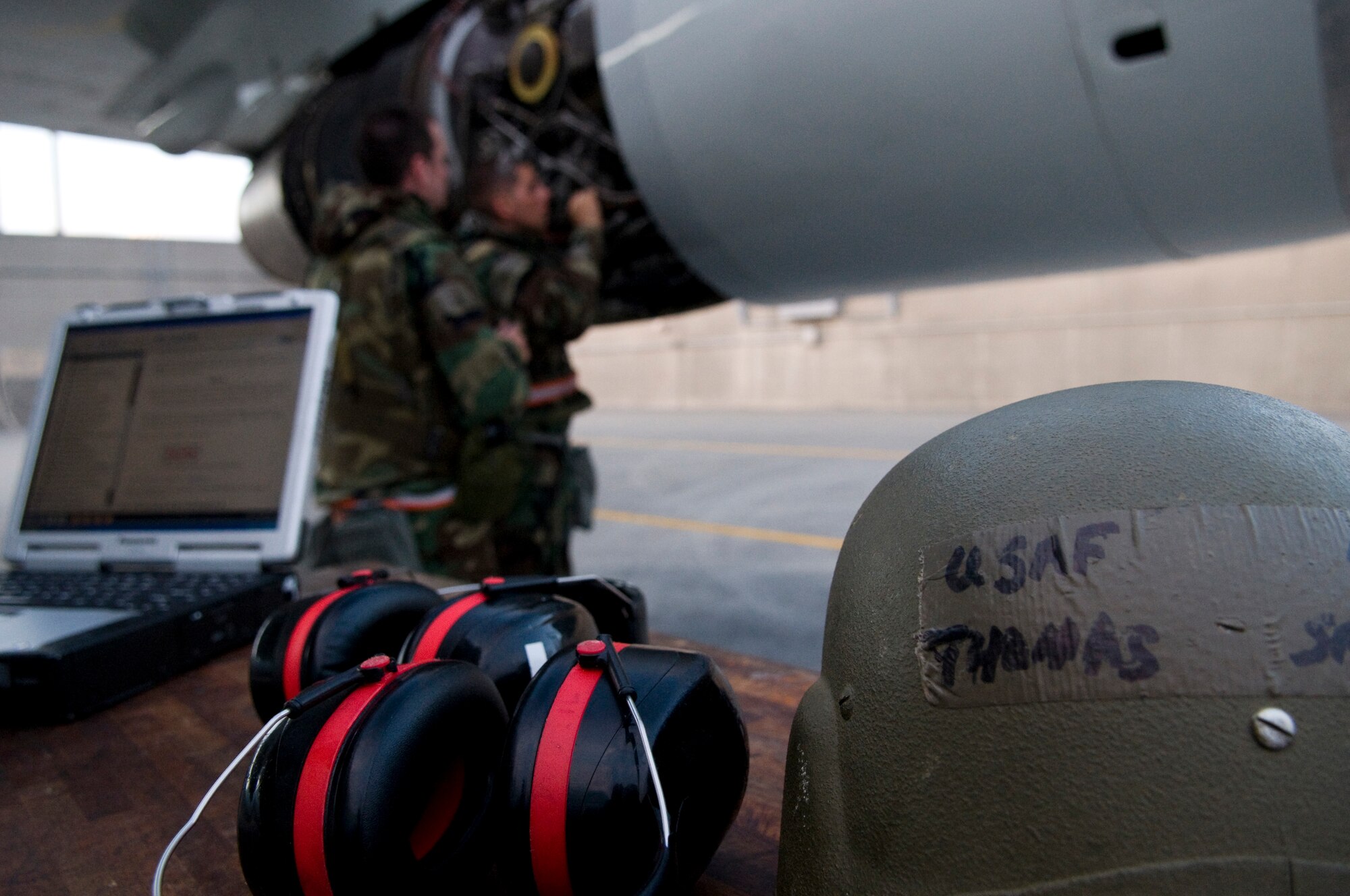 U.S. Air Force Staff Sgt. Christopher Grima, 718th Aircraft Maintenance Squadron aerospace propulsion craftsman, and Airman 1st Class Thomas Smith, 718th AMXS aerospace propulsion apprentice, change out an engine igniter plug on a U.S. Air Force E-3 Sentry surveillance aircraft while wearing Mission-Oriented Protective Posture gear as part of Beverly High 12-1, a local operational readiness exercise on Kadena Air Base, Japan, Oct. 27. During the exercise, Airmen across the base participated in several different scenarios to ensure they remain mission-ready. (U.S. Air Force photo/Airman 1st Class Maeson L. Elleman/released)
