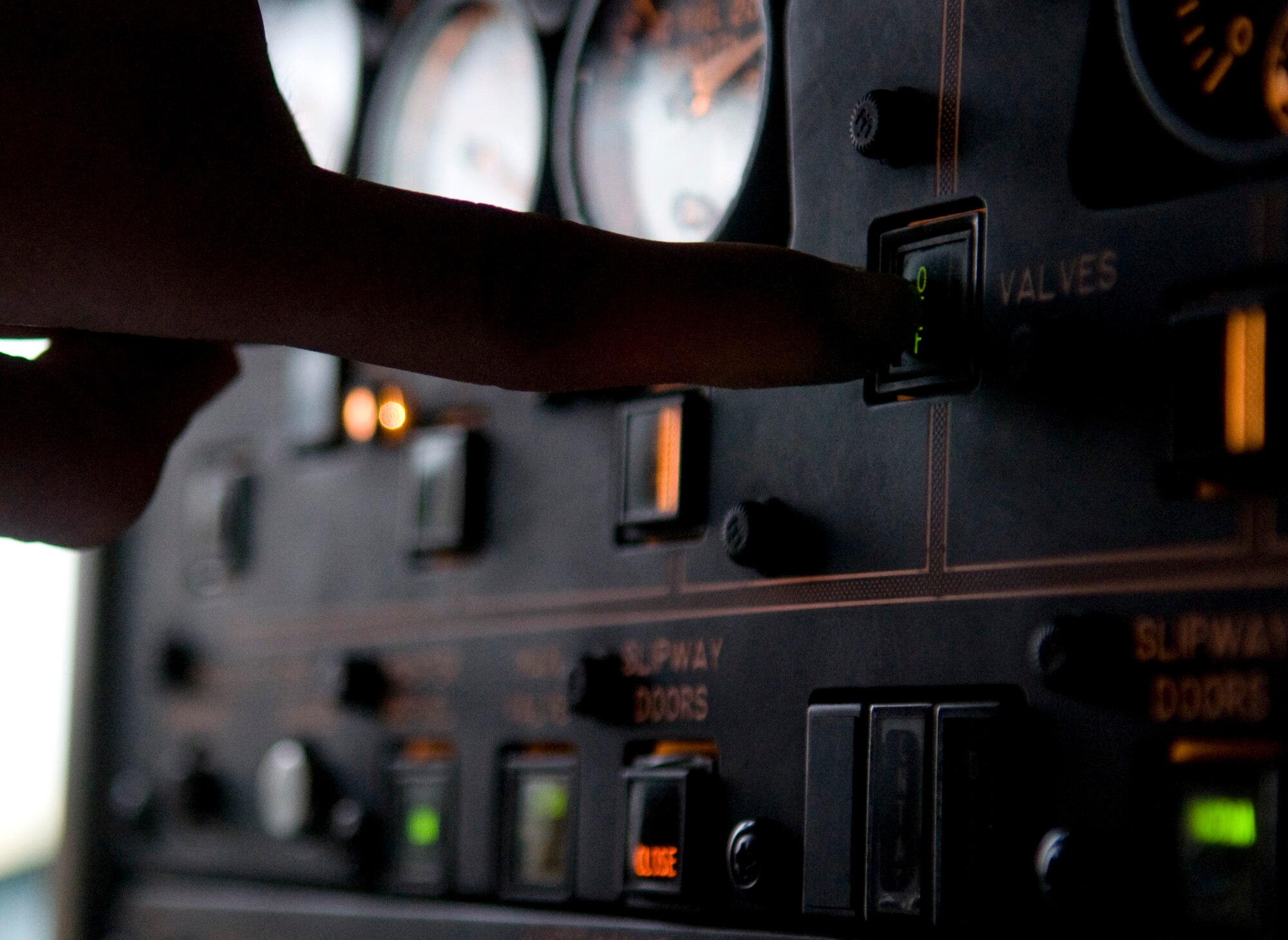 U.S. Air Force Airman 1st Class James Black, 718th Aircraft Maintenance Squadron assistant dedicated crew chief, presses an indicator during the refueling of a U.S. Air Force E-3 Sentry surveillance aircraft as part of Beverly High 12-1, a local operational readiness exercise on Kadena Air Base, Japan, Oct. 27. During LOREs, Airmen practice in different scenarios ranging from chemical attacks and unexploded ordnance discovery to self-aid and buddy care. (U.S. Air Force photo/Airman 1st Class Maeson L. Elleman/released)