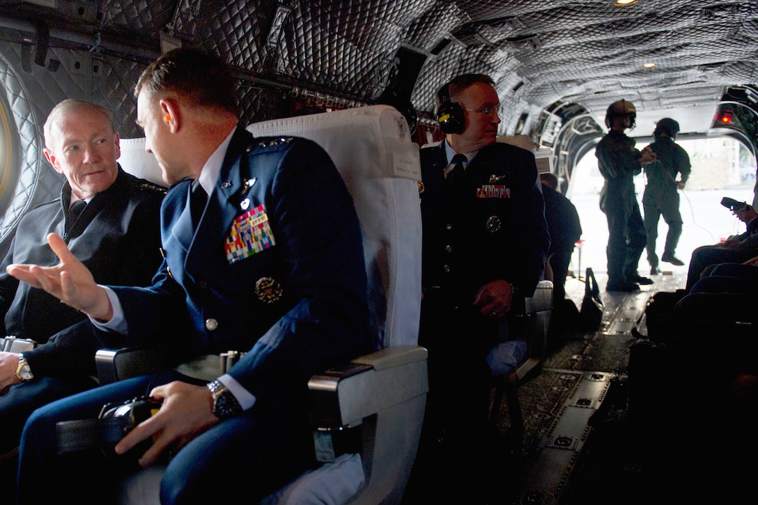 U.S. Air Force Lt. Gen. Burton M. Field, commander of U.S. Forces Japan, right, talks with U.S. Army Gen. Martin E. Dempsey, chairman of the Joint Chiefs of Staff, while aboard a Chinook CH-64 helicopter en route to Yokota Air Base, Japan, Oct. 28, 2011. 