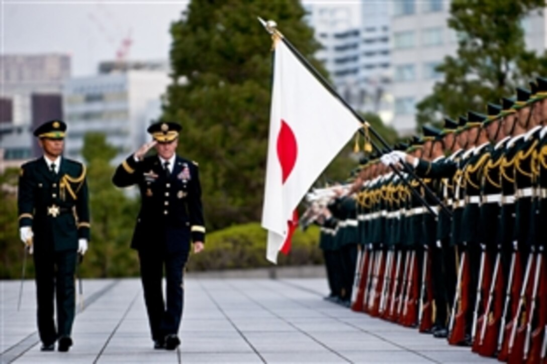 U.S. Army Gen. Martin E. Dempsey, chairman of the Joint Chiefs of Staff, salutes during a pass-in-review ceremony in Tokyo, Oct. 28, 2011.