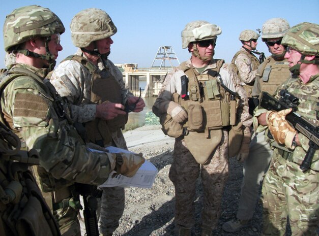 Col. Yori R. Escalante (middle), the assistant chief of staff C-9 for Regional Command Southwest, and Maj. Gen. John A. Toolan (second from left), the II Marine Expeditionary Force (Forward) commanding general, meet with British soldiers to learn about the canal repairs of the Darvishan Canal near the Garmsir District Center, Helmand province, Afghanistan, Oct. 30, 2011. The repairs were part of Operation Tethys, an operation to repair the canals in Helmand province. As the assistant chief of staff, Escalante overlooked development projects like this one.