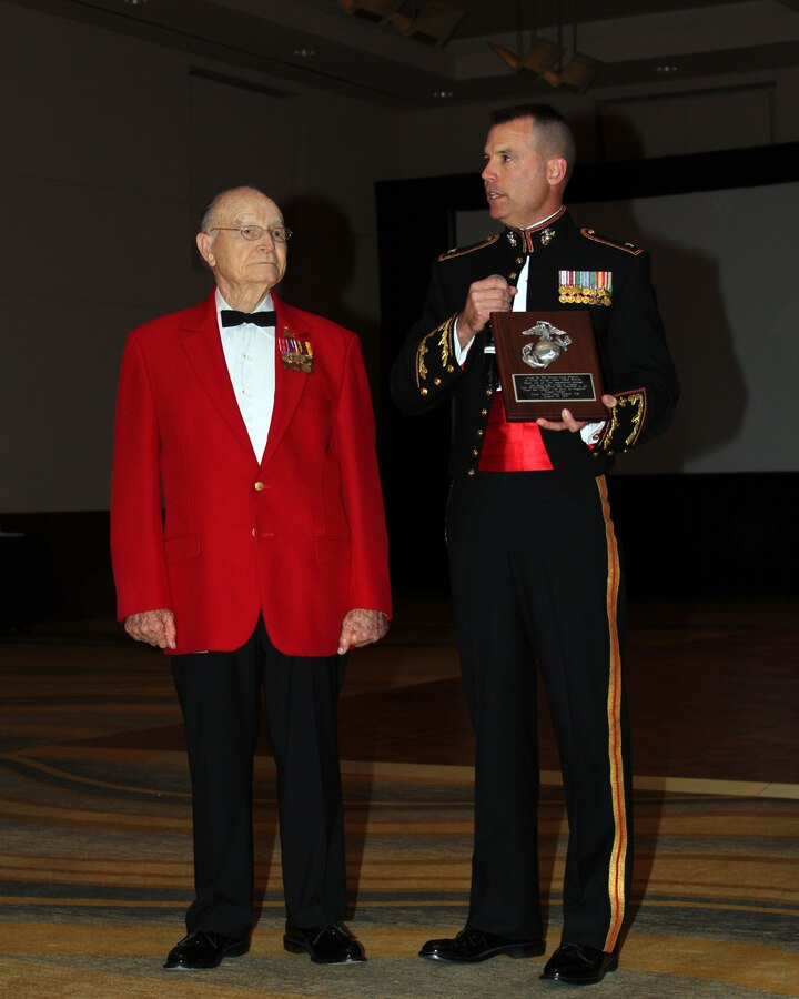 Col. Ted Studdard, 8th Marine Corps District commanding officer, presented guest of honor retired Lt. Col. George Alden a plaque expressing the district’s gratitude for joining in the celebration of the 236th Marine Corps Birthday Ball, Oct. 29 at the Marriott Solana in Westlake, Texas. Alden shared his experiences as a Marine during World War II and spoke of the undying connection that Marines will always have with Corps.