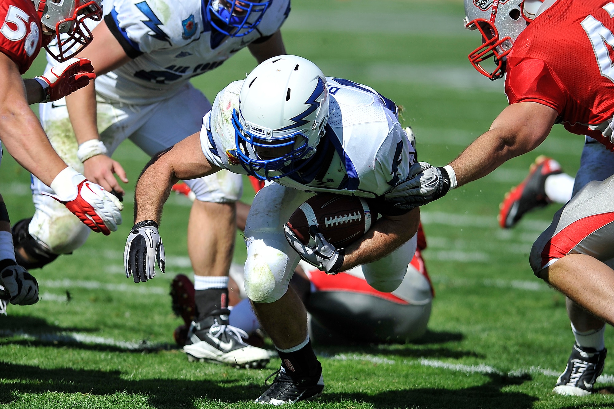 Falcons junior fullback Mike DeWitt plows ahead for yardage against New Mexico in the teams' matchup Oct. 29, 2011, in Albuquerque, N.M. DeWitt had 15 carries for 64 yards and four touchdowns against the Lobos, marking the first four-touchdown performance by a Falcon since Chad Hall did it against Colorado State in 2007. The Falcons relied on the strength of their running game, throwing only three times and punting only twice in a 42-0 shutout of New Mexico. (U.S. Air Force photo/Bill Evans)