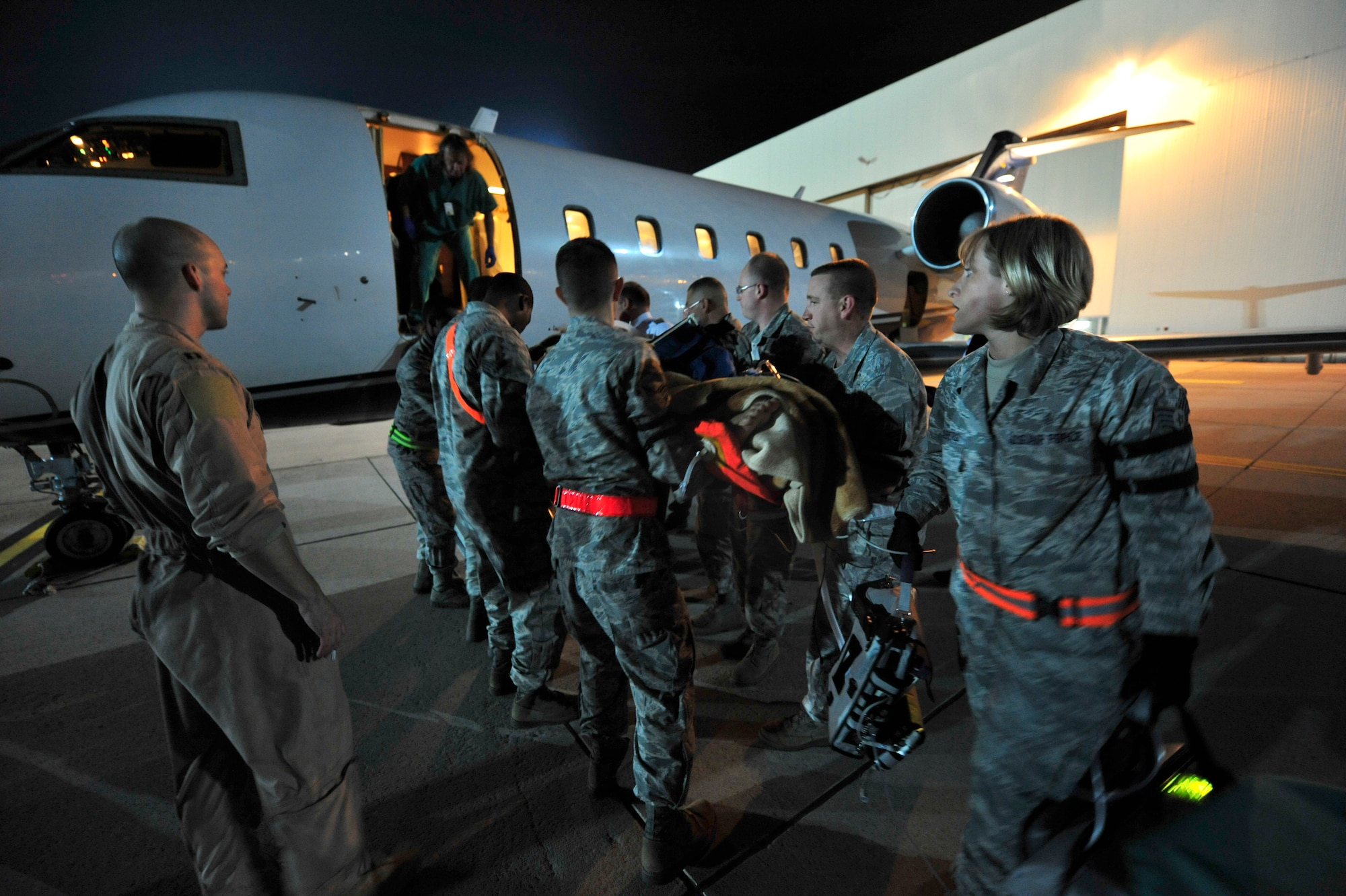 Airmen from the 86th Aeromedical Evacuation Squadron and a Critical Care Air Transport Team from Landstuhl Regional Medical Center, load a wounded Libyan fighter onto a civilian aircraft for transport to a local German hospital, Oct. 29, 2011, Ramstein Air Base, Germany. At the request of the Department of State and directed by the Secretary of Defense, USAFRICOM is supporting U.S. and international humanitarian relief efforts in Libya. Specifically, the U.S. military transported four wounded Libyans for treatment in medical facilities in Europe and 28 to the United States.  (U.S. Air Force Photo by Tech. Sgt. Chenzira Mallory)