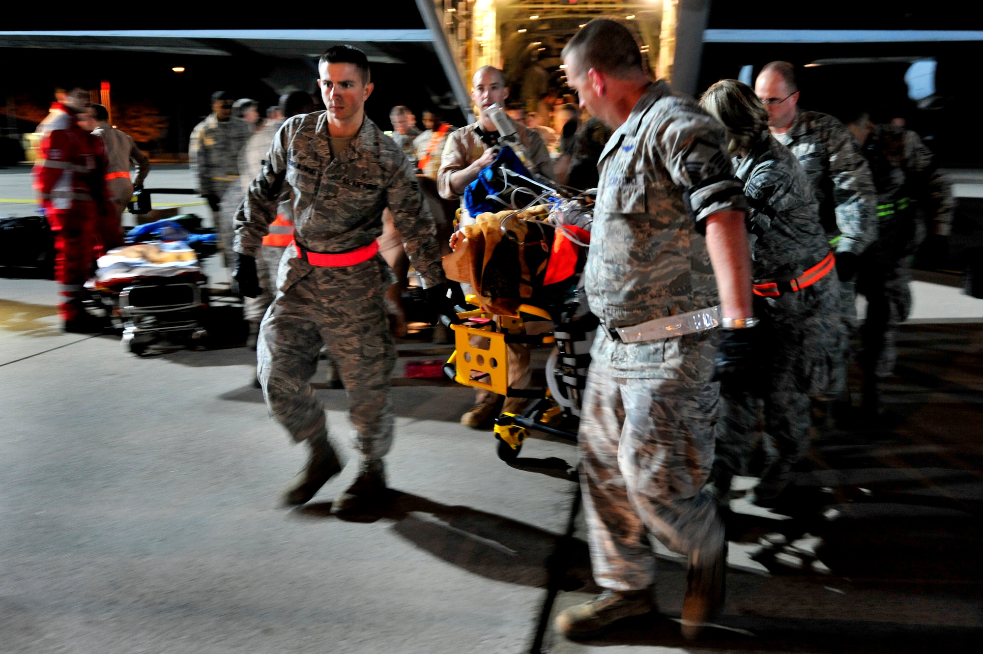 Airmen from the 86th Aeromedical Evacuation Squadron and a Critical Care Air Transport Team from Landstuhl Regional Medical Center unload wounded Libyan fighters from a C-130J Hercules, Oct. 29, 2011, Ramstein Air Base, Germany. At the request of the Department of State and directed by the Secretary of Defense, USAFRICOM is supporting U.S. and international humanitarian relief efforts in Libya. Specifically, the U.S. military transported four wounded Libyans for treatment in medical facilities in Europe and 28 to the United States.  (U.S. Air Force Photo by Tech. Sgt. Chenzira Mallory)