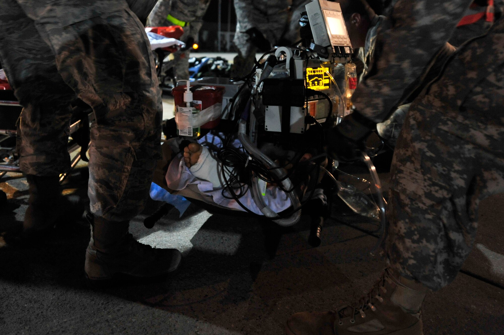 A Critical Care Air Transport Team from Landstuhl Regional Medical Center transport a wounded Libyan fighter to a gurney, Oct. 29, 2011, Ramstein Air Base, Germany. At the request of the Department of State and directed by the Secretary of Defense, USAFRICOM is supporting U.S. and international humanitarian relief efforts in Libya. Specifically, the U.S. military transported four wounded Libyans for treatment in medical facilities in Europe and 28 to the United States.  (U.S. Air Force Photo by Tech. Sgt. Chenzira Mallory)