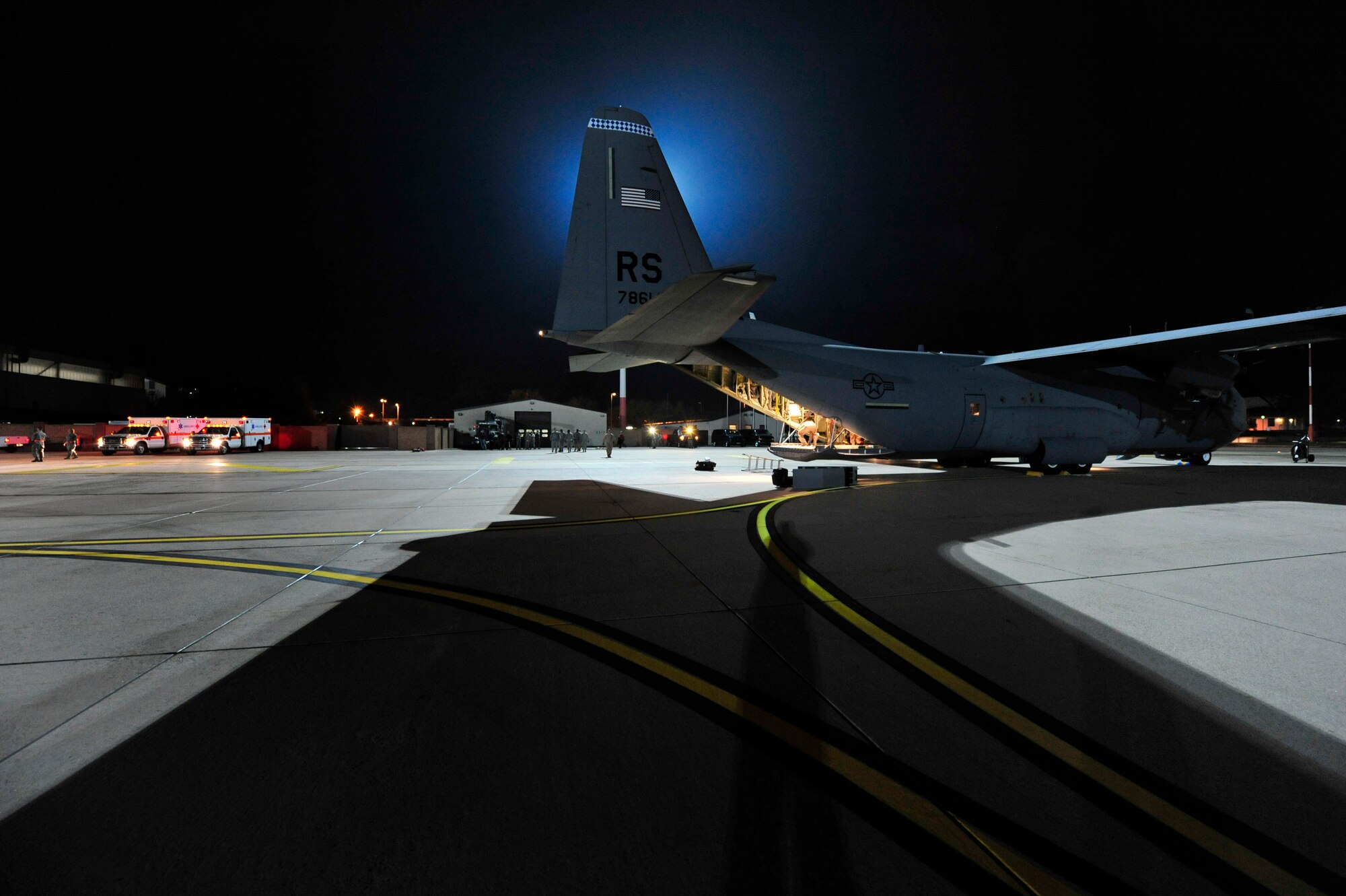 Ambulances and Airmen stand ready to unload wounded Libyan fighters from a C-130J Hercules, Oct. 29, 2011, Ramstein Air Base, Germany. At the request of the Department of State and directed by the Secretary of Defense, USAFRICOM is supporting U.S. and international humanitarian relief efforts in Libya. Specifically, the U.S. military transported four wounded Libyans for treatment in medical facilities in Europe and 28 to the United States.  (U.S. Air Force Photo by Tech. Sgt. Chenzira Mallory)