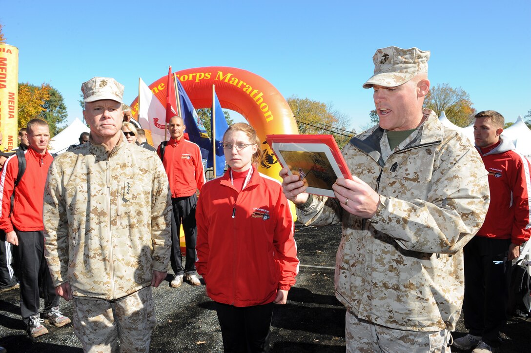 The 35th commandant of the Marine Corps, General James F. Amos, and the 17th sergeant major of the Marine Corps, Sergeant Major Micheal P. Barrett, reenlist Corporal Christine M. Kunish at the Marine Corps Marathon in Washington, D.C., October 30,  2011. (U.S. Marine Corps photo by Sgt. Ben Flores)(RELEASED)::r::::n::