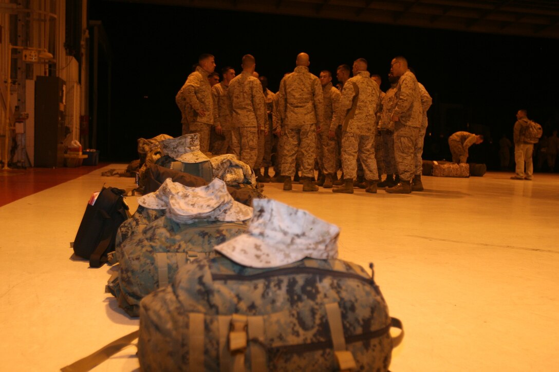 Marines from VMA-223 circle up around each other to address last minute questions and concerns they have before they go to the armory to draw weapons Sunday night. "I'm excited and a little nervous because this is my first time deploying, but I'm sure that once I get out there I'll be fine," said Lance Cpl. Javier Fernandez a power plants mechanic with MAG-14. The squadron falls under the command of Marine Aircraft Group 14 and 2nd Marine Aircraft Wing.