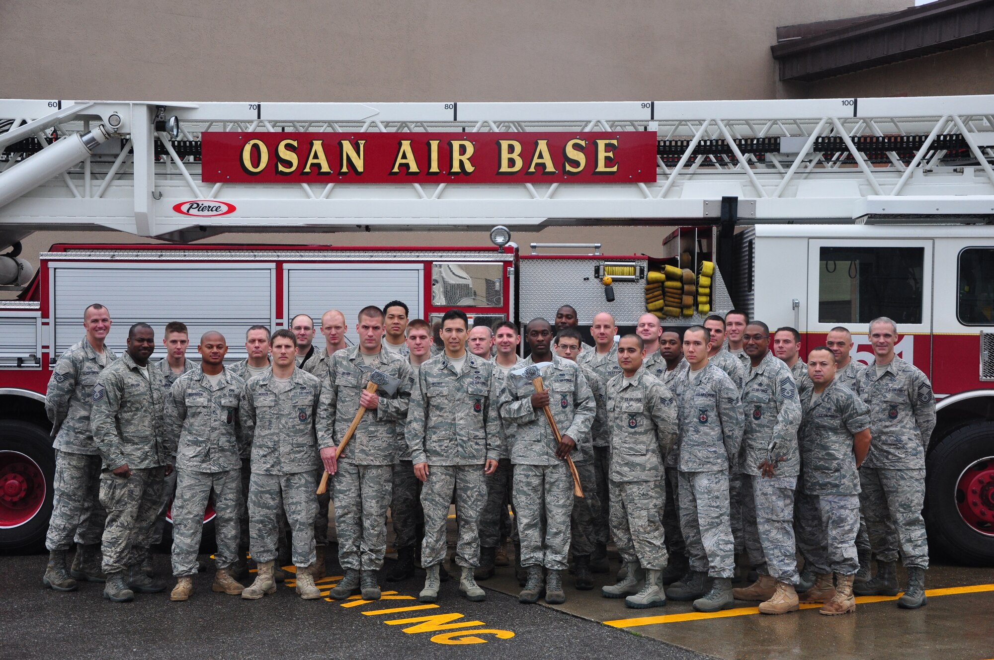 A group photo of the 51st Civil Engineer Squadron Fire Department, with Chief Master Sgt. Reco Houston, fire chief, standing three people from the right in the front row. Houston will be awarded the 49th Annual Korean National Fire Fighter's Day Gyeonggi Province Governor Award during a ceremony Nov, 4, 2011. Although the award will be presented to him, he said it will be proudly displayed as recognition of his team's efforts and viewed as an encouragement to press forward. (U.S. Air Force photo/Tech. Sgt. Chad Thompson)