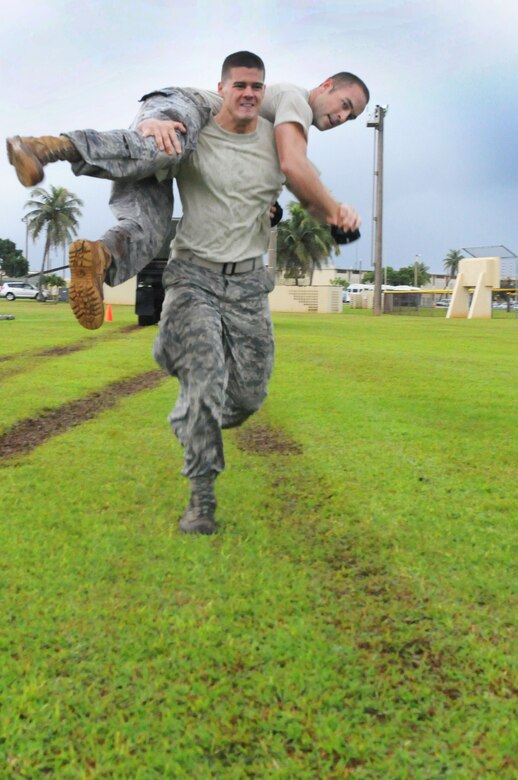 Two  Airman from Andersen's 36th Contingency Response Group complete the
fireman carry during the 36th Contingency Response Group's warrior challenge
here, Oct. 21. Each squadron assigned to the 36 CRG competed against each
other during the challenge.  (U.S. Air Force photo/Senior Airman Carlin
Leslie)

