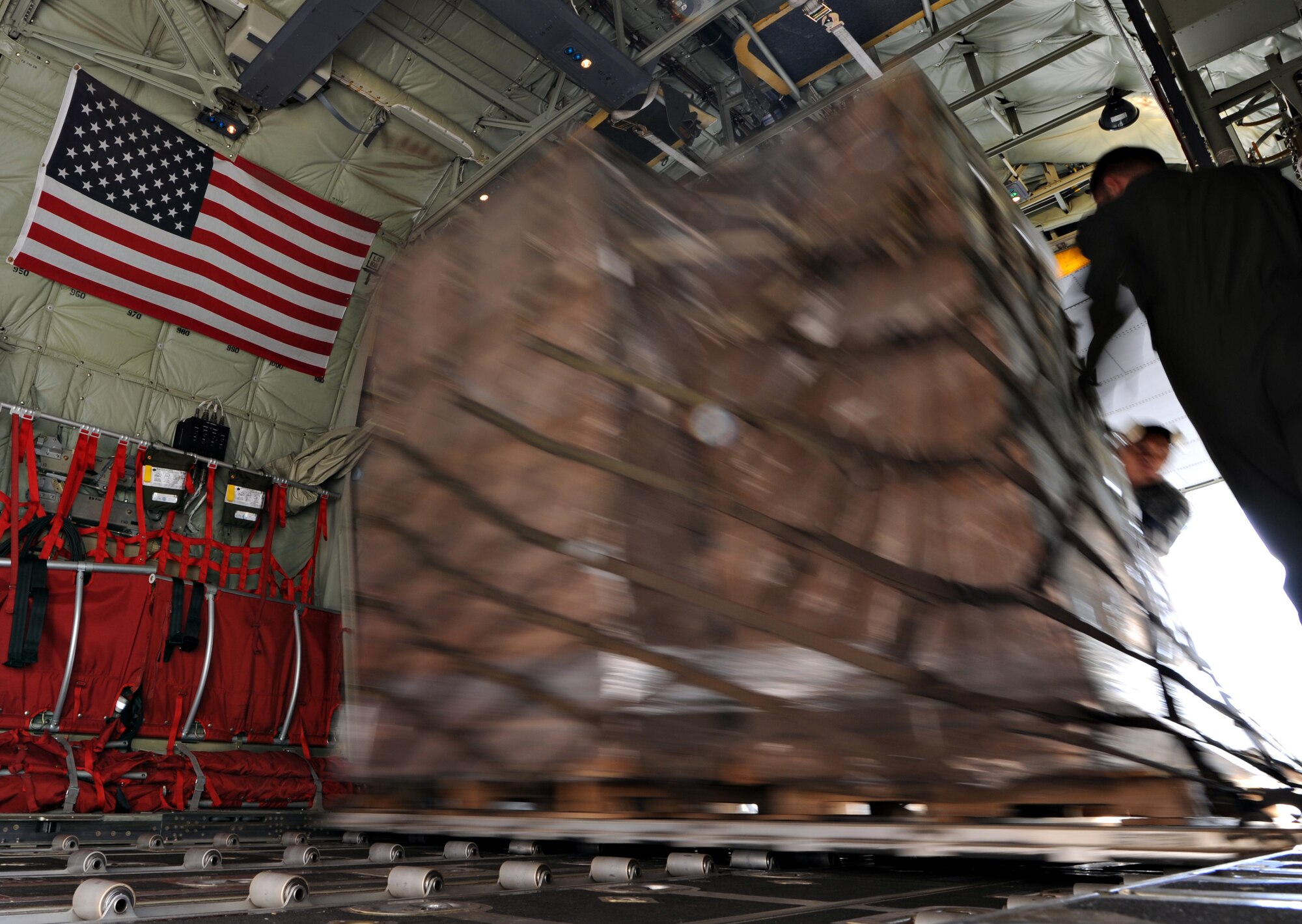 Members of the 37th Airlift Squadron load supplies onto a C-130J Super Hercules, Oct. 29, 2011, Ramstein Air Base, Germany. The cargo consisted of blankets, cots and tents flown to Turkey as humanitarian aid for the victims of a major earthquake that occurred in north-eastern Turkey recently.
