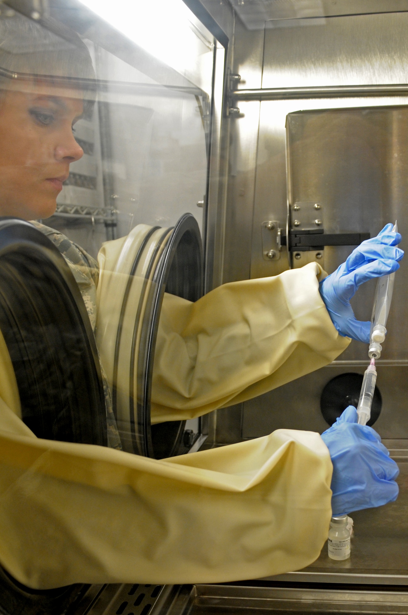 BAGRAM AIRFIELD, Afghanistan – Master Sgt. Heather Agnew, 455th Expeditionary Medical Group pharmacy technician, disposes an intravenous drip in an approved container to ensure a sterile environment. Agnew is deployed from Wright-Patterson Air Force Base, Ohio, and is a native of Forestville, New York. (U.S. Air Force photo/ Senior Airman Krista Rose)