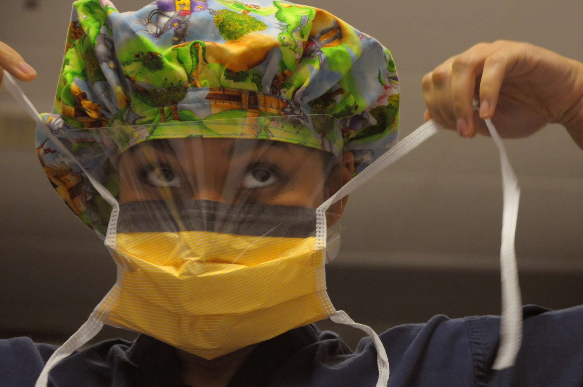 BAGRAM AIRFIELD, Afghanistan -- Tech. Sgt. Latisha Shirley, 455th Expeditionary Medical Group surgical technician, puts on a mask before surgery Oct. 29, 2011. Shirley is deployed from Andrews Air Force Base, M.D., and is a native of Anderson, S.C. (U.S. Air Force photo/ Senior Airman Krista Rose)