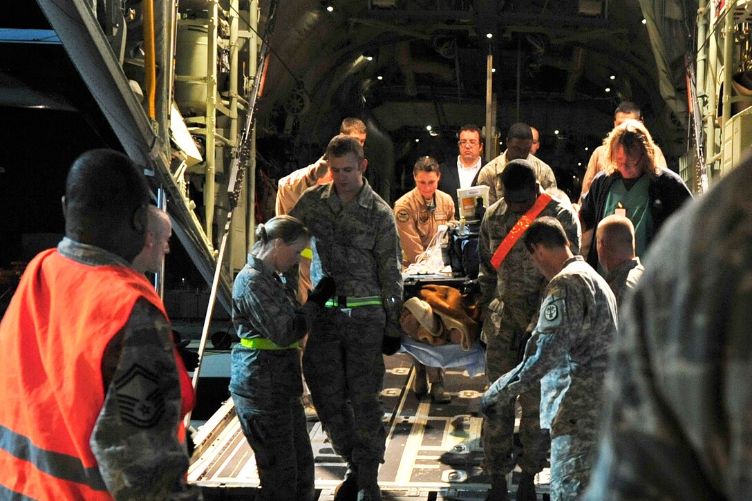 U.S. Air Force airmen from the 86th Aeromedical Evacuation Squadron and a critical care air transport team from Landstuhl Regional Medical Center unload wounded Libyan fighters from a C-130J Hercules airplane on  Ramstein Air Base, Germany, Oct. 29, 2011. 