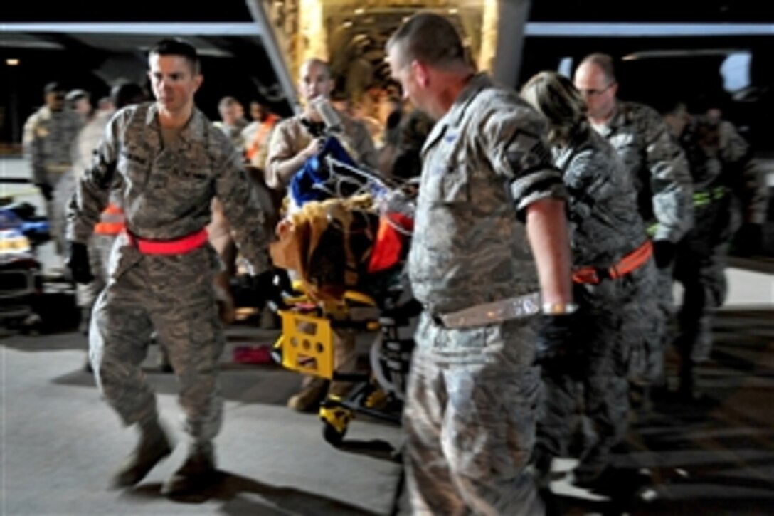 U.S. airmen and members of a critical care air transport team from Landstuhl Regional Medical Center unload wounded Libyan fighters from a C-130J Hercules aircraft on Ramstein Air Base, Germany, Oct. 29, 2011. The airmen are assigned to the 86th Aeromedical Evacuation Squadron. U.S. Africa Command is supporting U.S. and international humanitarian relief efforts in Libya at the request of the Department of State and directed by the secretary of defense.