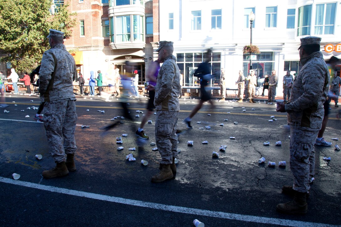 Marines distribute water to racers at the 36th annual Marine Corps Marathon Oct. 30.  Marines set up water and Gatorade stations along the route to refresh the 30,000 participants.