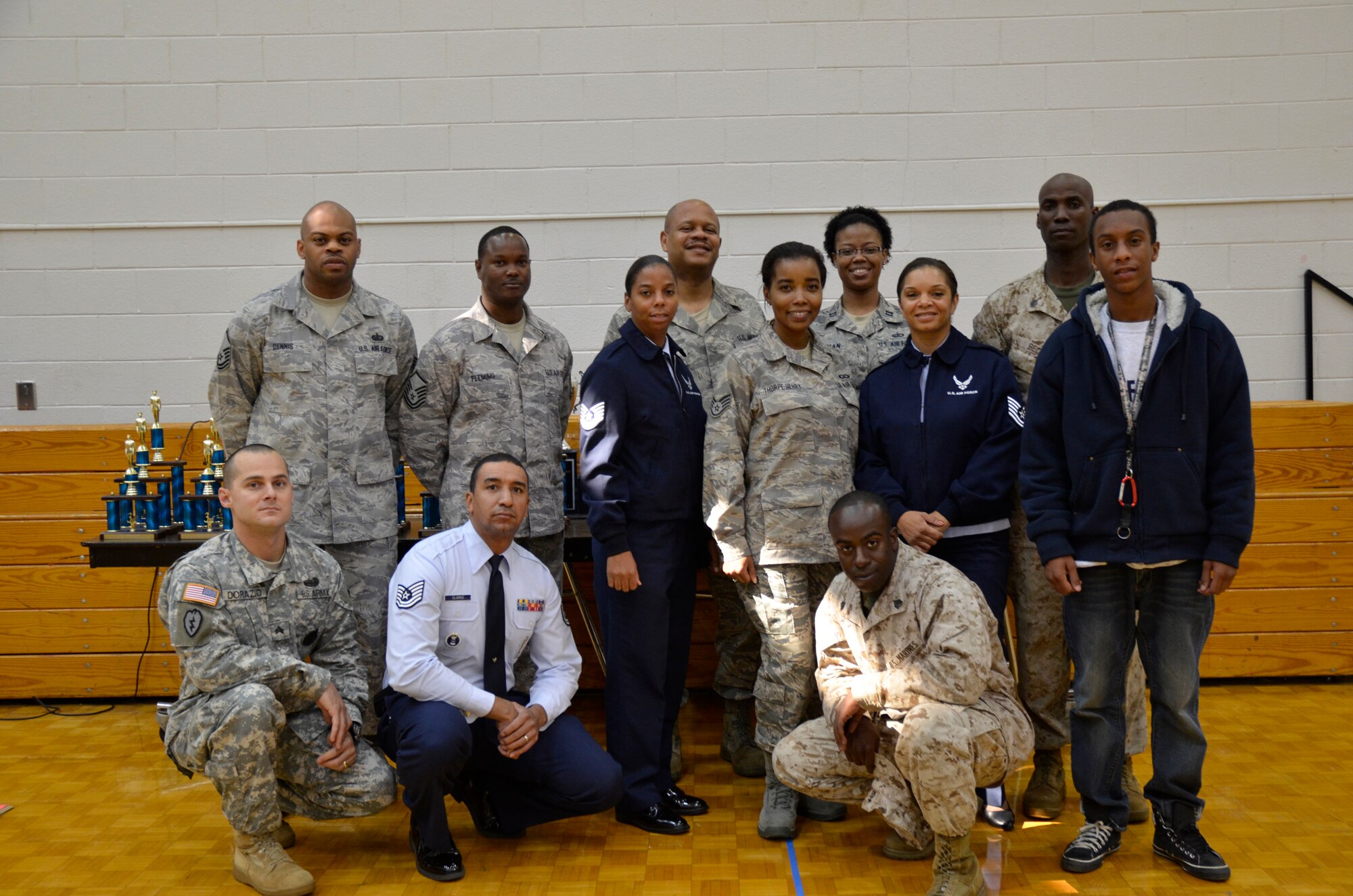 Several servicemembers, including Airmen from Dobbins, pose at the Mt. Zion High School drill competition Nov. 29.  They volunteered their  time to serve as judges during the Air Force Junior Reserve Officer Training Corps competition in Clayton County. (U.S. Air Force photo/ Senior Airman Danielle Campbell Purnell)