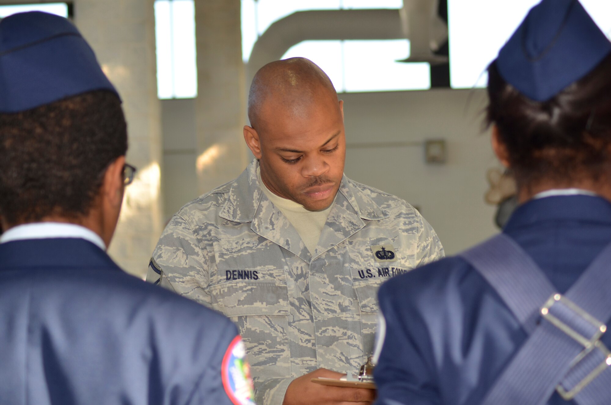 Master Sgt. Travon Dennis of the 94th Airlift Wing judges an Honor Guard competition the Mt. Zion High School drill meet Nov. 29.  Six Airmen from Dobbins volunteered their time to serve as judges during the Air Force Junior Reserve Officer Training Corps competition in Clayton County. (U.S. Air Force photo/ Senior Airman Danielle Campbell Purnell)