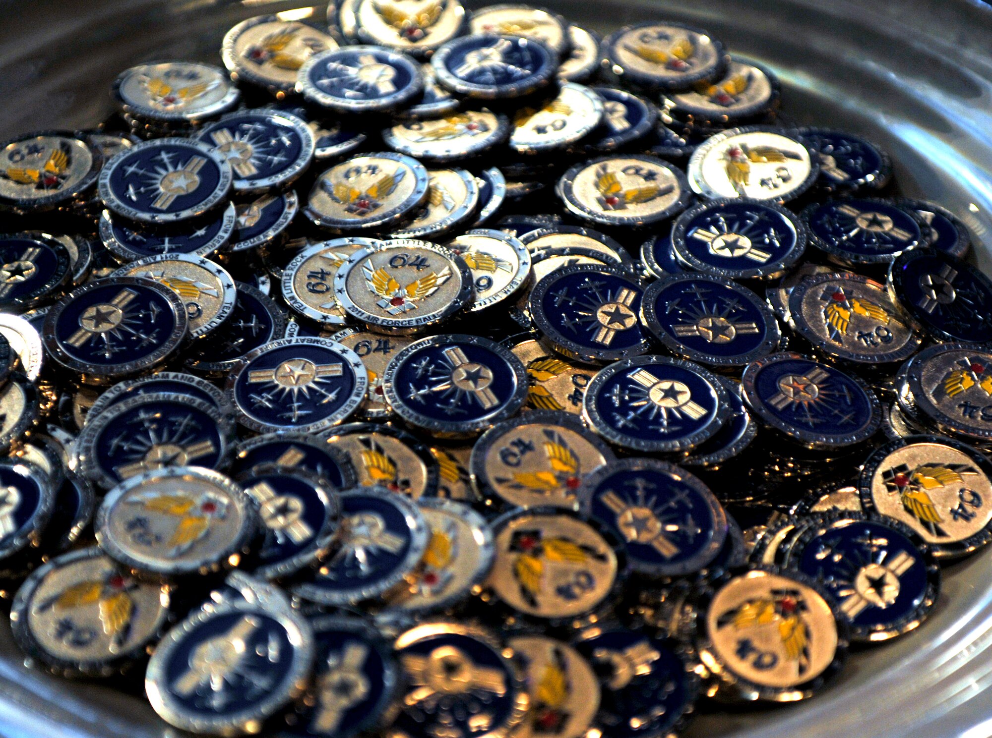 Coins are given out as a token of remembrance Oct. 29, for the 64th Air Force Ball, at Little Rock Air Force Base, Ark. More than 700 people came out for the event and celebrated the accomplishments of Team Little Rock over the past year. (U.S. Air Force photo by Senior Airman Caleb Pierce) 