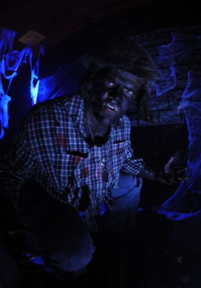 Airman 1st Class Joses Carpenter, 7th Munitions Squadron, acts as a werewolf in the haunted house during the annual Fall Festival, Oct. 29, 2011, at Dyess Air Force Base. Fall Fest offered Dyess families events such as candy booths, costume contests, carnival games and a haunted house.  (U.S. Air Force photo by Airman 1st Class Peter Thompson/Released)