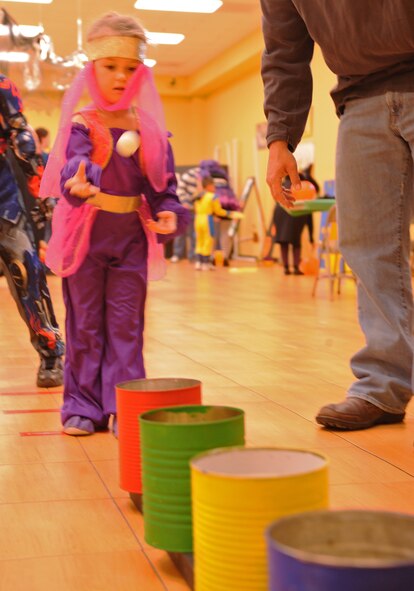 A child plays a game during the annual Fall Festival, Oct. 28, 2011, at Dyess Air Force Base, Texas. Fall Fest offered Dyess families events such as candy booths, costume contests, carnival games and a haunted house. (U.S. Air Force photo by Airman 1st Class Peter Thompson/Released) 