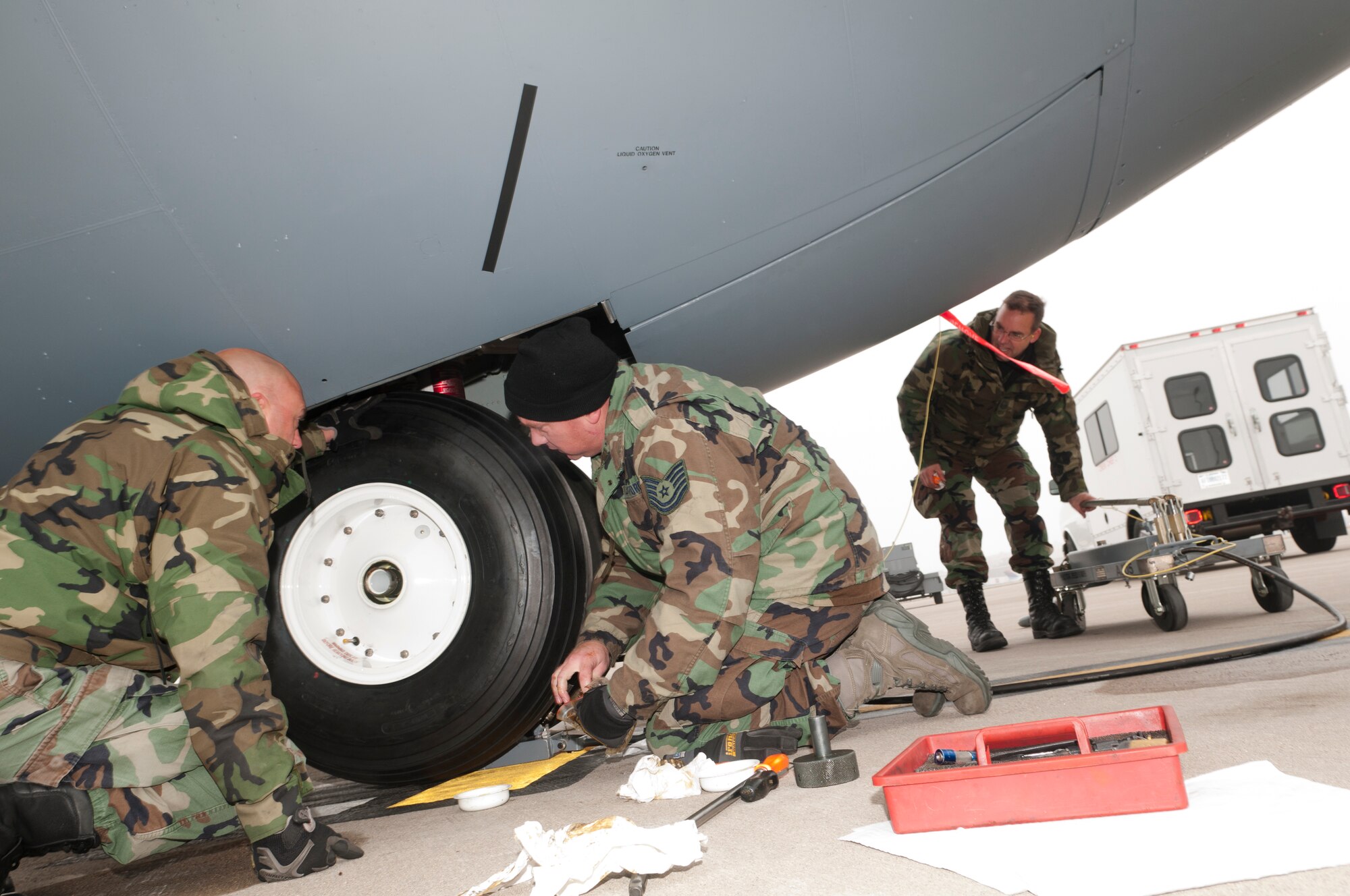 Maintenance Airmen change a tire on a Minnesota Air National Guard C-130 “Hercules” on the flightline at the Minneapolis – St. Paul international airport, on Oct. 31, 2011 wearing the Battle Dress Uniform on the last official day the Air Force allows BDUs to be worn. From left to right, Technical Sgt. Brad Dahl of the 133rd Maintenance Squadron, Technical Sgt. Dan Whitehead of the 133rd Aircraft Maintenance Squadron and Master Sgt. Tom Heckman, also from 133rd AMXS get the job done. USAF official photo by Senior Master Sgt. Mark Moss