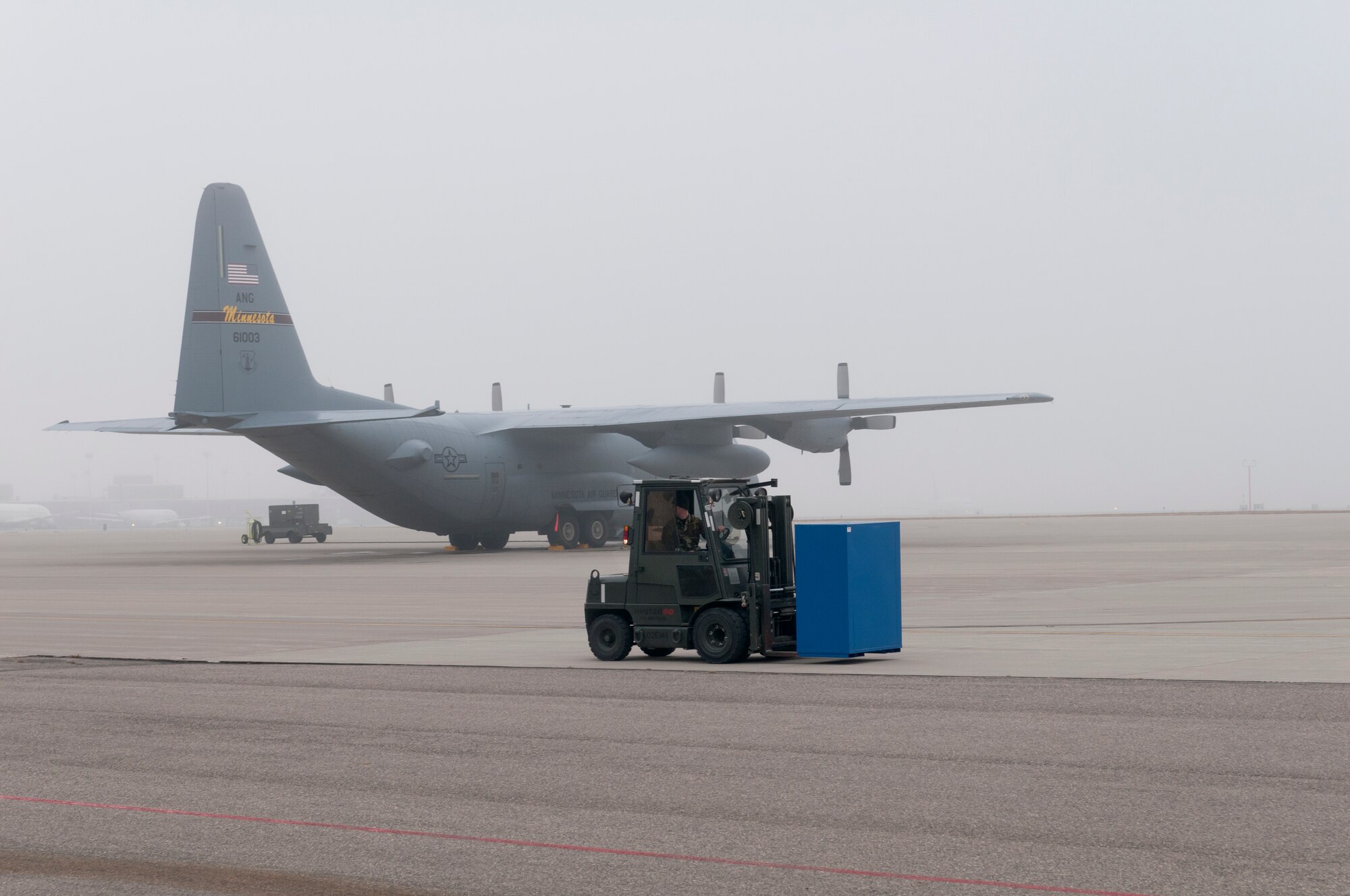 As fog lifts above the flightline at the Minneapolis – St. Paul international airport, Technical Sgt. Eric Moan of the 133rd Aircraft Maintenance Squadron drives a forklift in front a Minnesota Air National Guard C-130 “Hercules” on Oct. 31, 2011. Moan is one of dozens of Airmen on base wearing the Battle Dress Uniform on the last official day the Air Force allows BDUs to be worn. USAF official photo by Senior Master Sgt. Mark Moss