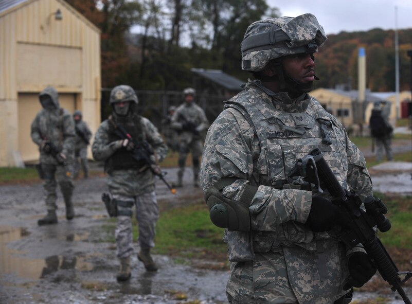 U.S. Air Force Staff Sgt. Calvin Hicklin, 105th Security Forces Squadron fire team leader, leads a foot patrol around the training site in search for improvise explosive devices at Camp Smith, N.Y., Oct. 27, 2011. The 823rd BDS and the 105th Security Forces Squadron were integrated together to standardize training between the two squadrons. (U.S. Air Force photo by Staff Sgt. Stephanie Mancha/Released)