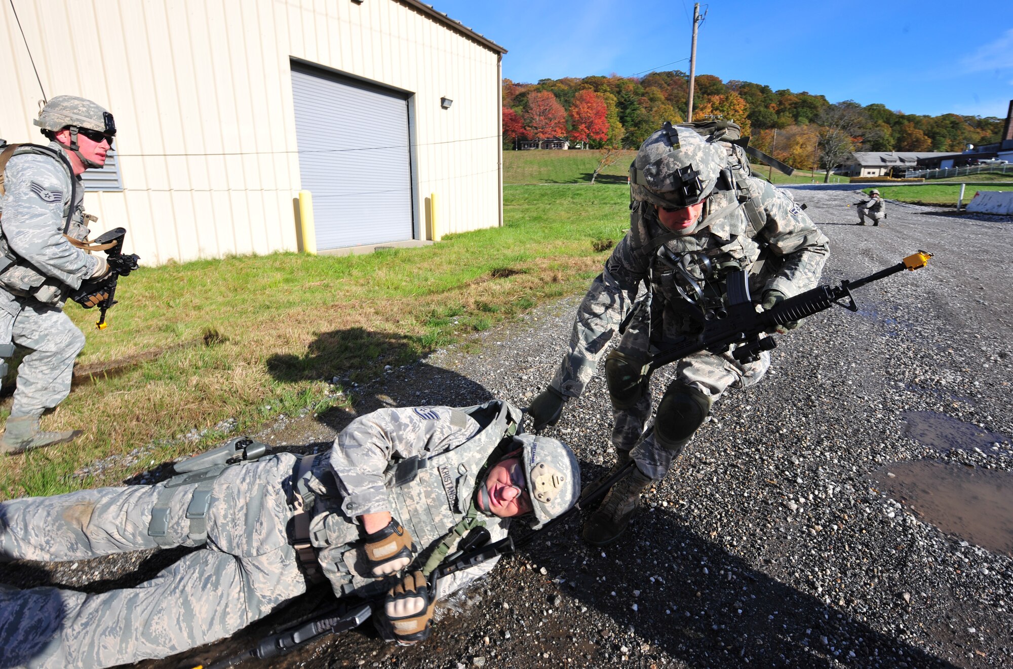 U.S. Air Force Airman Sergio Maturana, 105th Security Forces Squadron fire team member, drags Staff Sgt. Erik Kristensen, 823rd Base Defense Squadron fire team leader, out of the danger zone after being shot during a foot patrol exercise at Camp Smith, N.Y. Oct 28, 2011. The training and exercise were as realistic as possible to allow Airmen to prepare for future deployments. The 823rd BDS brought everything they needed as if they were going to a bare base. (U.S. Air Force photo by Staff Sgt. Stephanie Mancha/Released)
