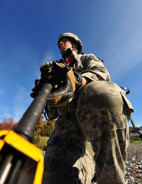 U.S. Air Force Staff Sgt. Erik Kristensen, 823rd Base Defense Squadron fire team leader, takes a knee while patrolling a village during an exercise at Camp Smith, N.Y., Oct. 28, 2011. Airmen from the 823rd BDS and 105th Security Forces Squadron trained together for a week and then had to implement everything they learned into a 36-hour field training exercise which prepared them for future deployments. (U.S. Air Force photo by Staff Sgt. Stephanie Mancha/Released)