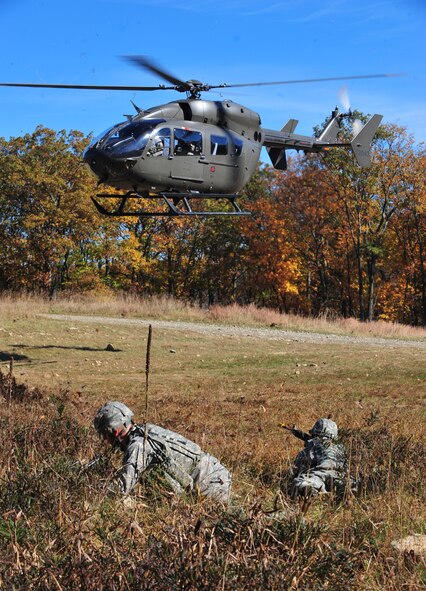 U.S. Air Force Airmen provide cover for the helicopter during an exercise at Camp Smith, N.Y., Oct 28, 2011. This was the first time the 823rd Base Defense Squadron and 105th Security Forces Squadron were able to implement a real helicopter medical evacuation into their training. (U.S. Air Force photo by Staff Sgt. Stephanie Mancha/Released)