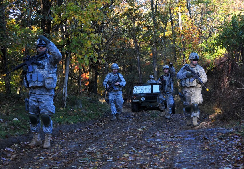 Members of the 823rd Base Defense Squadron and 105th Security Forces Squadron patrol the surrounding area of the base during an exercise at Camp Smith, N.Y., Oct 28, 2011. The unit was searching for suspicious activities while securing the base. (U.S. Air Force photo by Staff Sgt. Stephanie Mancha/Released)