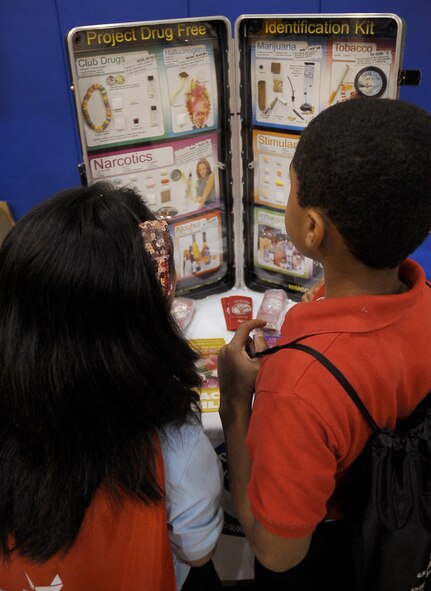 Barksdale children view a display about good and bad drugs during the Red Ribbon Week pledge event on Barksdale Air Force Base, La., Oct. 27. The children were joined by Col. Thomas Hesterman, 2nd Bomb Wing vice commander, Chief Master Sgt. Larry Malcom, 2 BW command chief, Sparky the fire mascot and McGruff the crime fighting dog to take a drug-free pledge. (U.S. Air Force photo/Senior Airman Amber Ashcraft)(RELEASED)