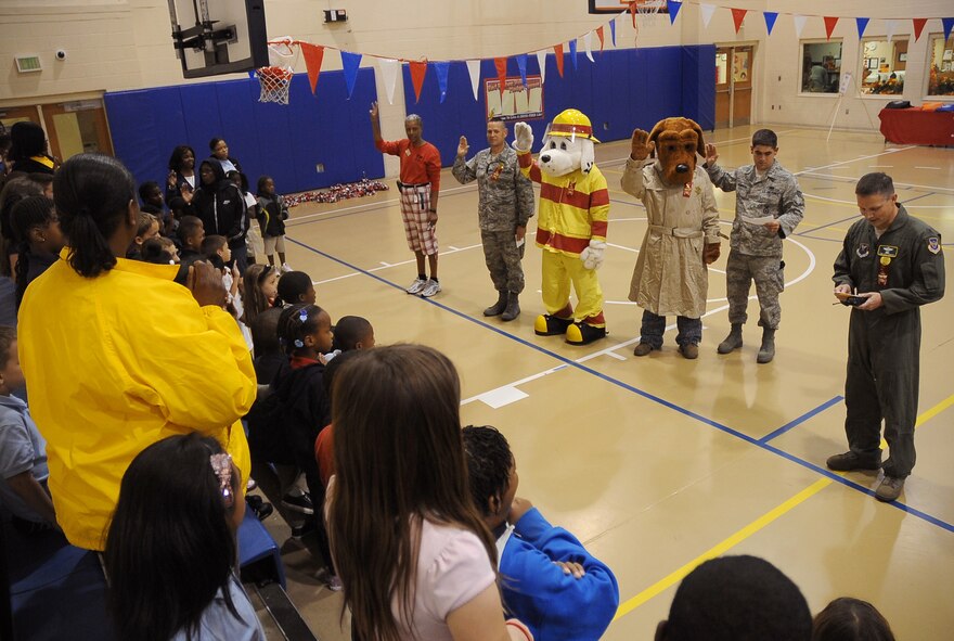 Barksdale children take the drug-free pledge with Col. Thomas Hesterman, 2nd Bomb Wing vice commander, and friends on Barksdale Air Force Base, La., Oct. 27. Hesterman was joined by Chief Master Sgt. Larry Malcom, 2 BW command chief, Sparky the fire mascot and McGruff the crime fighting dog, to take the drug-free pledge at the Red Ribbon Week pledge event at the Youth Center. More than 50 children attended and received back-packs filled with treats for taking the pledge. (U.S. Air Force photo/Senior Airman Amber Ashcraft)(RELEASED)