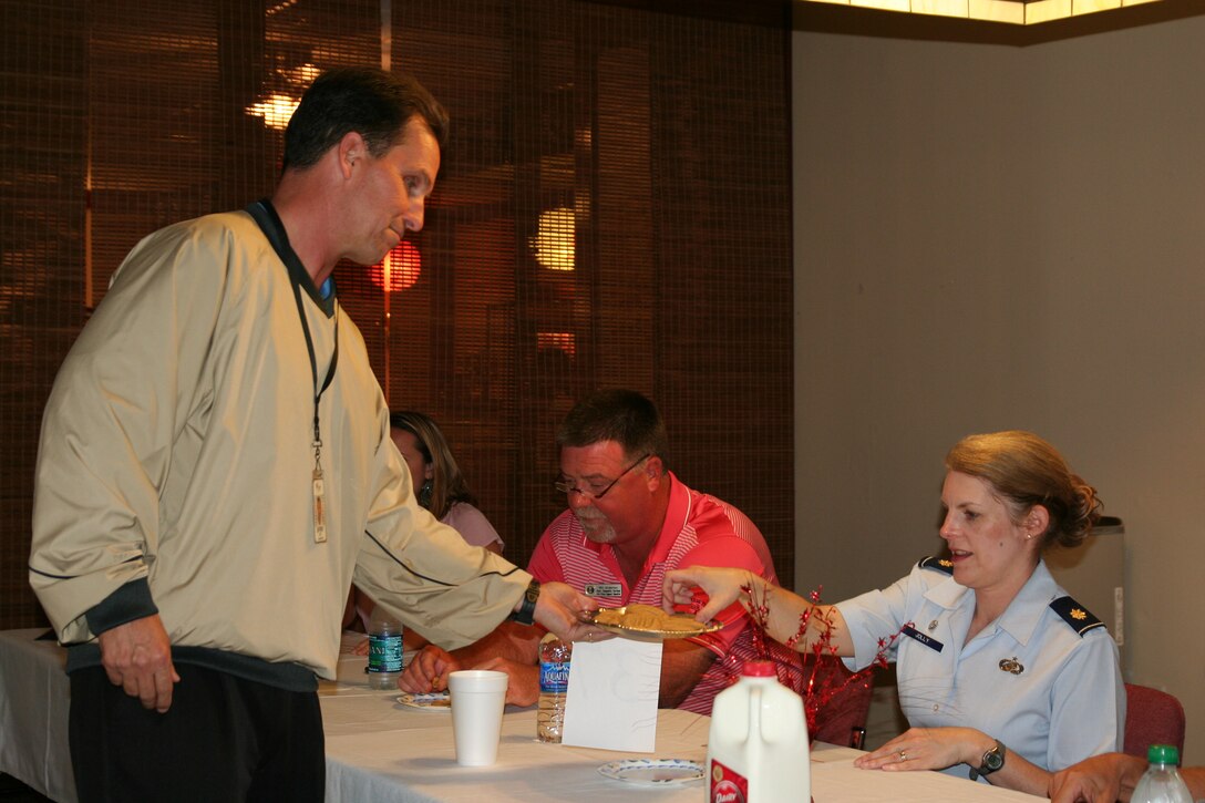 Jeffery Rice offers cookies to Maj. Natalie Jolly, 42nd Force Support Squadron Commander and a judge during a baking competition held Monday at the Maxwell Event Center. (Air Force photo/Kelly Deichert)