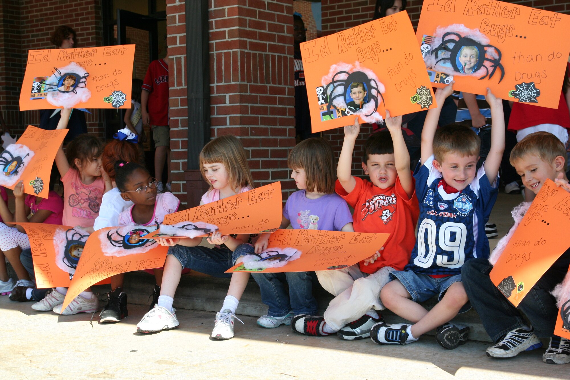 Kindergartners hold up signs Monday celebrating Red Ribbon Week at Maxwell Elementary Middle School. (Air Force photo/Kelly Deichert)
