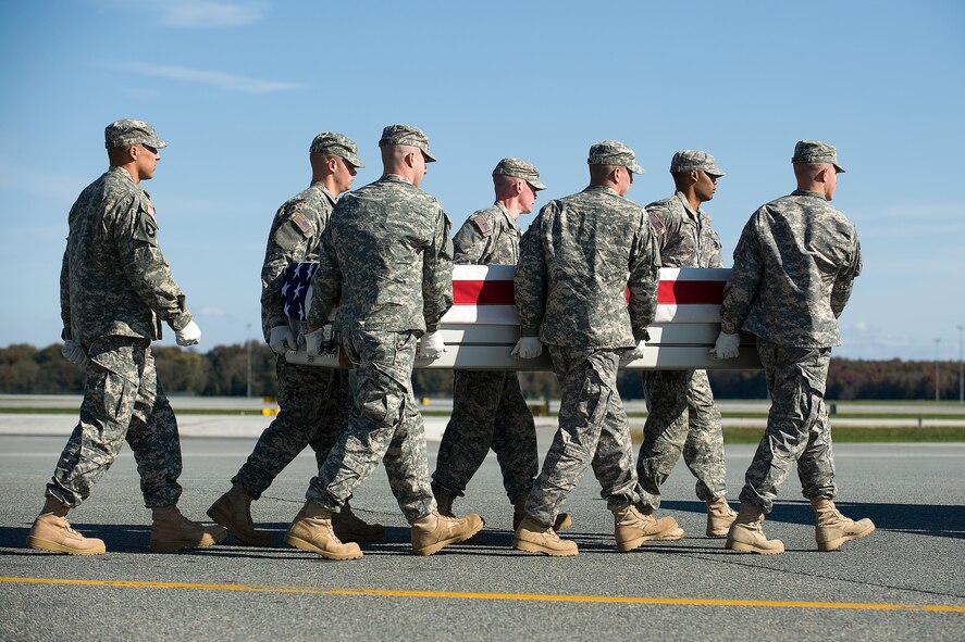 A U.S. Army carry team transfers the remains of Army Sgt. Carlo F. Eugenio, of Rancho Cucamonga, Calif, at Dover Air Force Base, Del., Oct. 31, 2011. Eugenio was assigned to the 756th Transportation Company, Van Nuys, Calif. (U.S. Air Force photo/Steve Kotecki)
