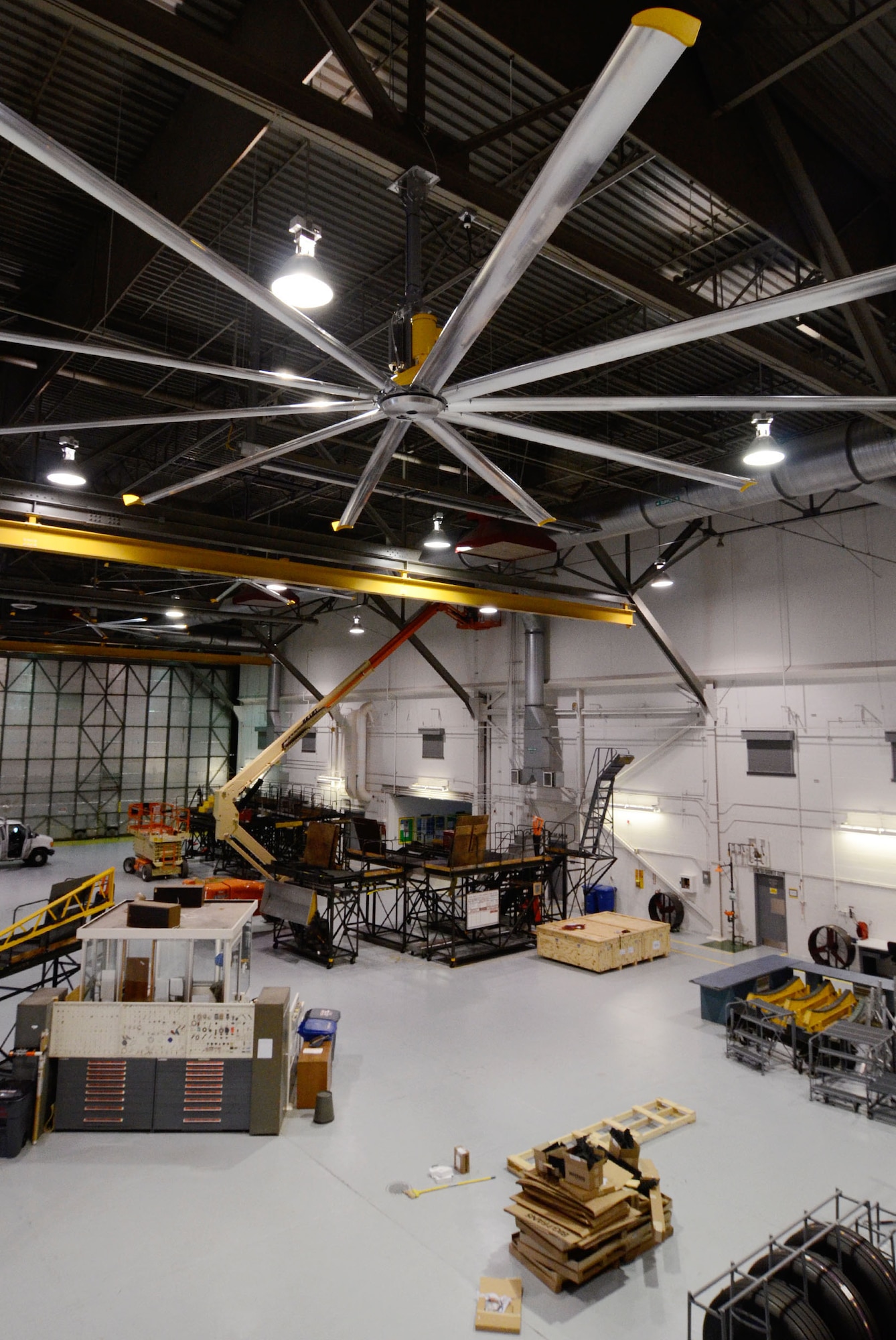 The Installation of large 24-foot ceiling fans provide aircraft maintenance personnel with seasonally comfortable air circulation throughout  hangar bay 3 in building 838 here Oct. 27. (U.S. Air Force photo/Don Peek)