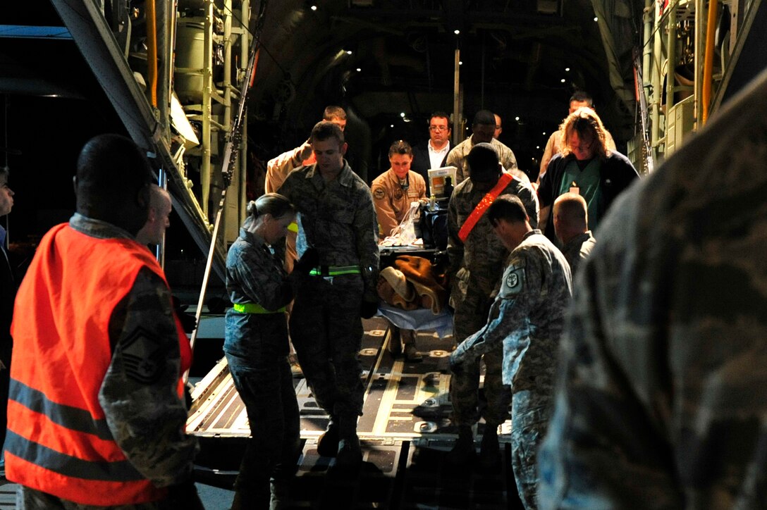 Airmen from the 86th Aeromedical Evacuation Squadron and a Critical Care Air Transport Team from Landstuhl Regional Medical Center unload wounded Libyan fighters from a C-130J Hercules on Oct. 29, 2011, at Ramstein Air Base, Germany. At the request of the Department of State and directed by the Secretary of Defense, U.S. Africa Command supported U.S. and international humanitarian relief efforts in Libya. Specifically, the U.S. military transported four wounded Libyans for treatment in medical facilities in Europe and 28 to the United States. (U.S. Air Force Photo/Tech. Sgt. Chenzira Mallory)