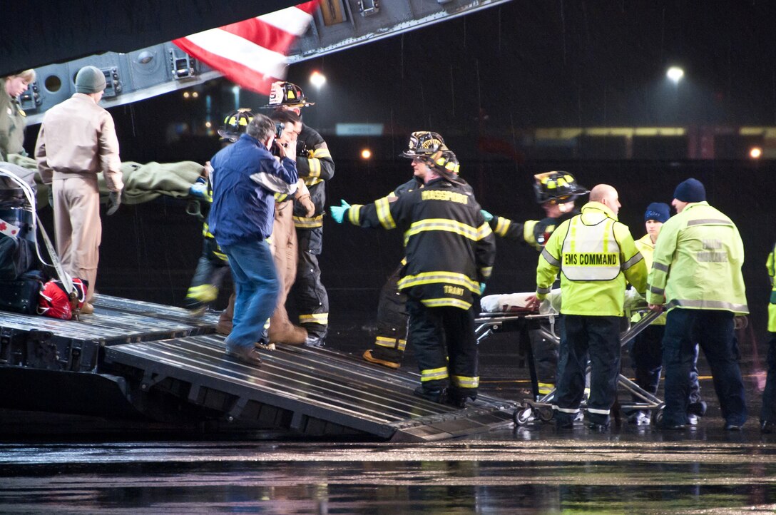 U.S. Air Force aeromedical evacuation crews, along with local emergency medical personnel, assist Libyan fighters off a C-17 at Boston Logan Airport, Mass., on Oct. 29, 2011. At the request of the Department of State and directed by the Secretary of Defense, the U.S. military is supporting U.S. and international medical assistance efforts in Libya. Specifically, the U.S. Air Force transported 22 wounded Libyans to Spaulding Rehabilitation Hospital in Salem, Mass. (U.S. Air Force Photo/Walter Santos)