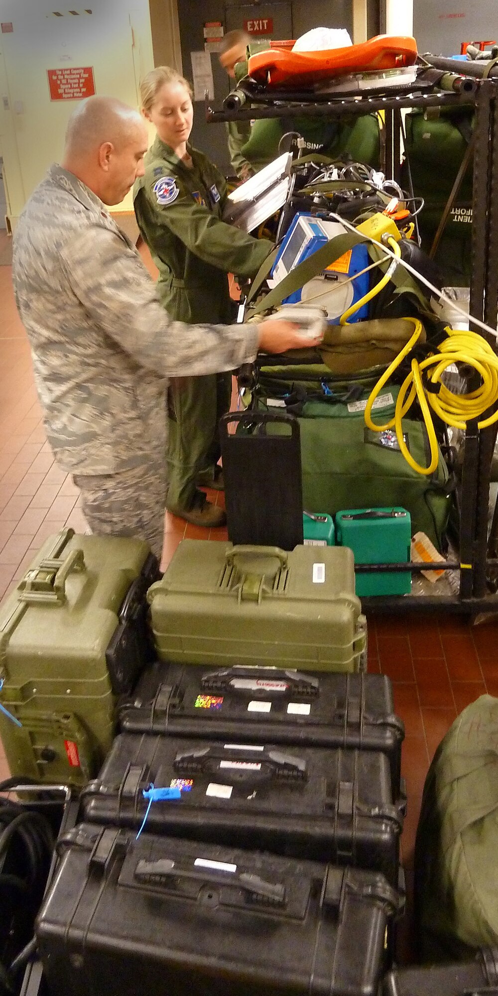Tech. Sgt. Yayee Thayer (left) works with Capt. Jennifer Lewis (center) and Senior Airman Benjamin Pace at Ramstein Air Base, Germany, on Oct. 28, 2011, double checking medical supplies for a humanitarian assistance mission evacuating 26 injured freedom fighters from Tripoli, Libya. Thayer and Pace are team members from the 86th Aeromedical Evacuation Squadron based at Ramstein Air Base, Germany. Two aircraft transported 26 seriously wounded fighters to Spaulding Rehabilitation Hospital in Boston, Mass. An additional five critical cases were transferred to Germany for immediate care. All patients were injured as a result of recent fighting and suffer from conditions that cannot currently be treated in Libya. (U.S. Army Photo/Pvt. Richard Bartell)